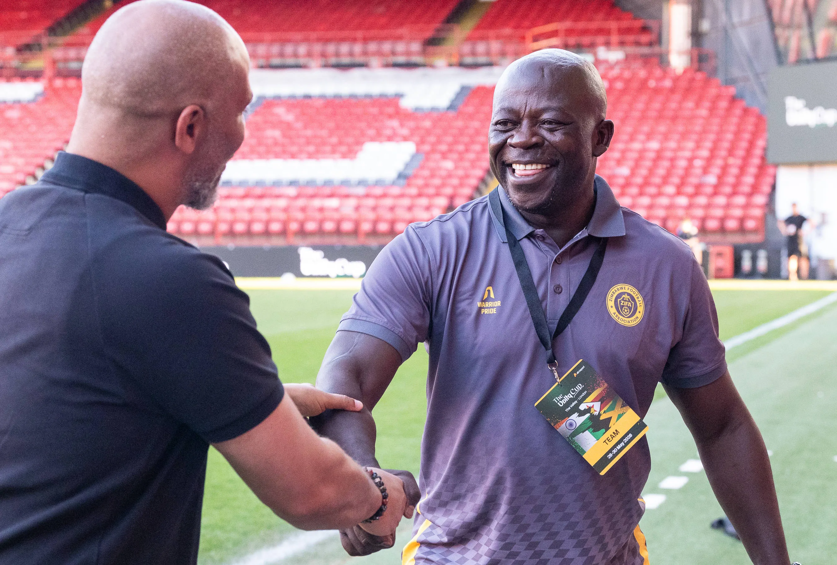 Eric Chelle greets Zimbabwe manager Kaitano Tembo