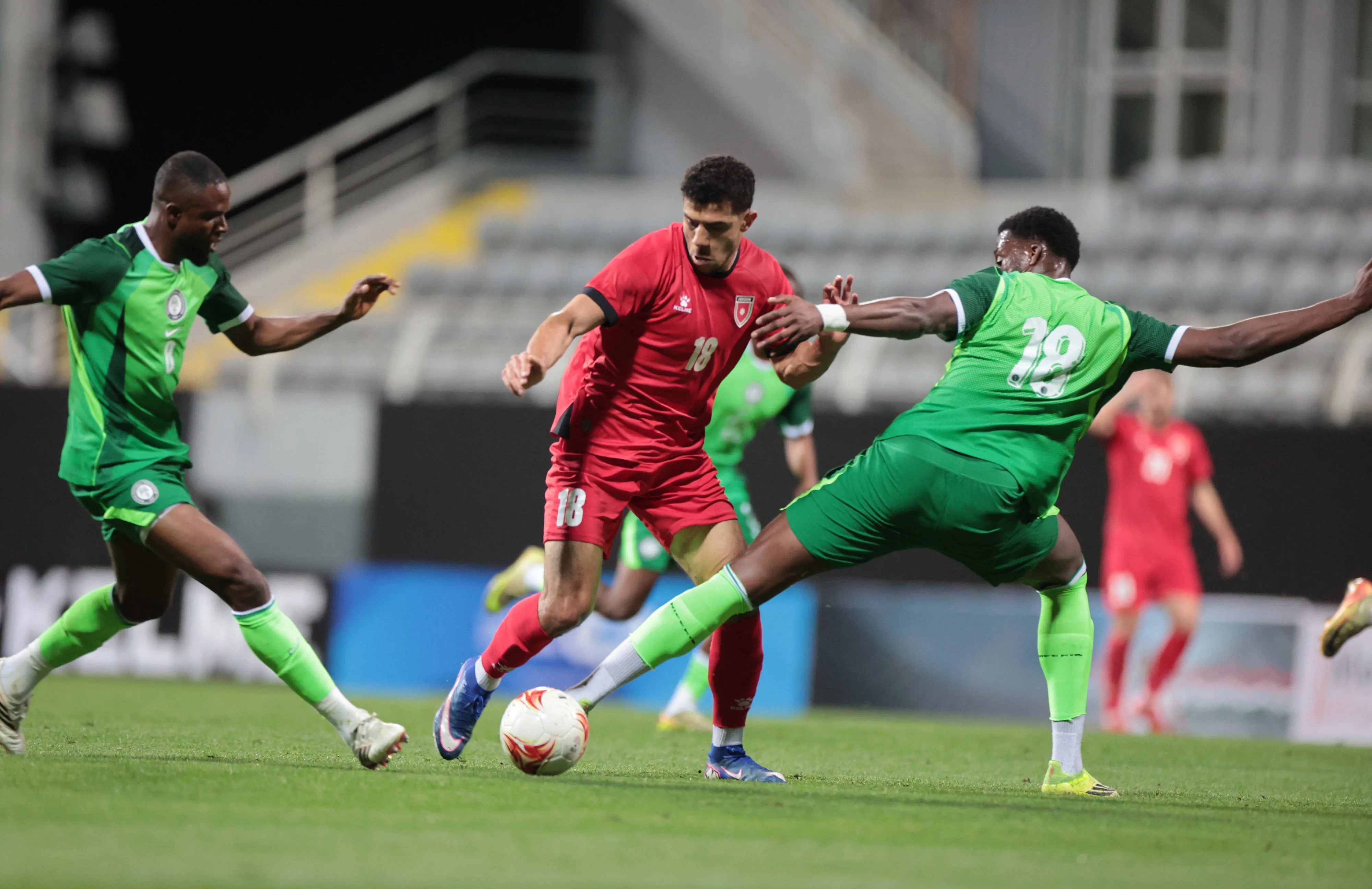 Ibrahim Sabra takes on Emmanuel Fernandez and Samuel Chukwueze