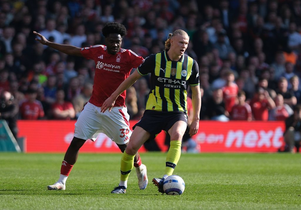 Erling Haaland of on the ball under pressure from Ola Aina during the match between Nottingham Forest and Manchester City