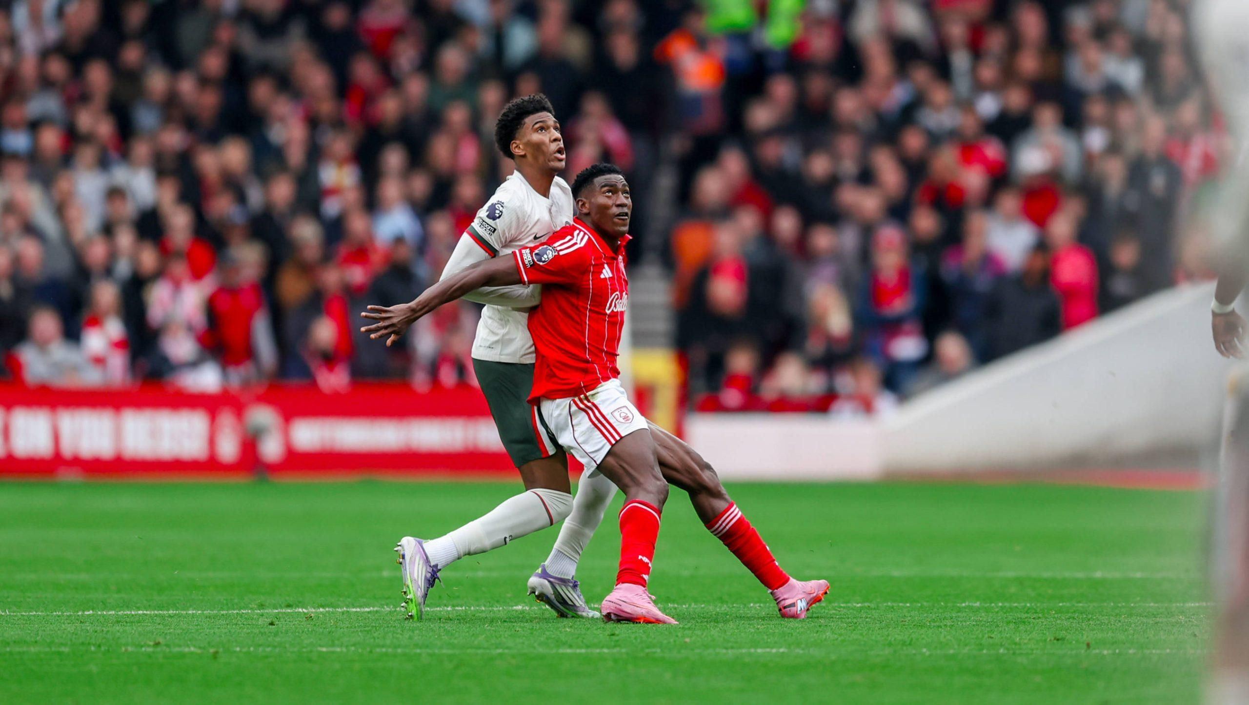 Josh Acheampong challenges forward Taiwo Awoniyi during the Premier League match between Nottingham Forest and Chelsea at the City Ground