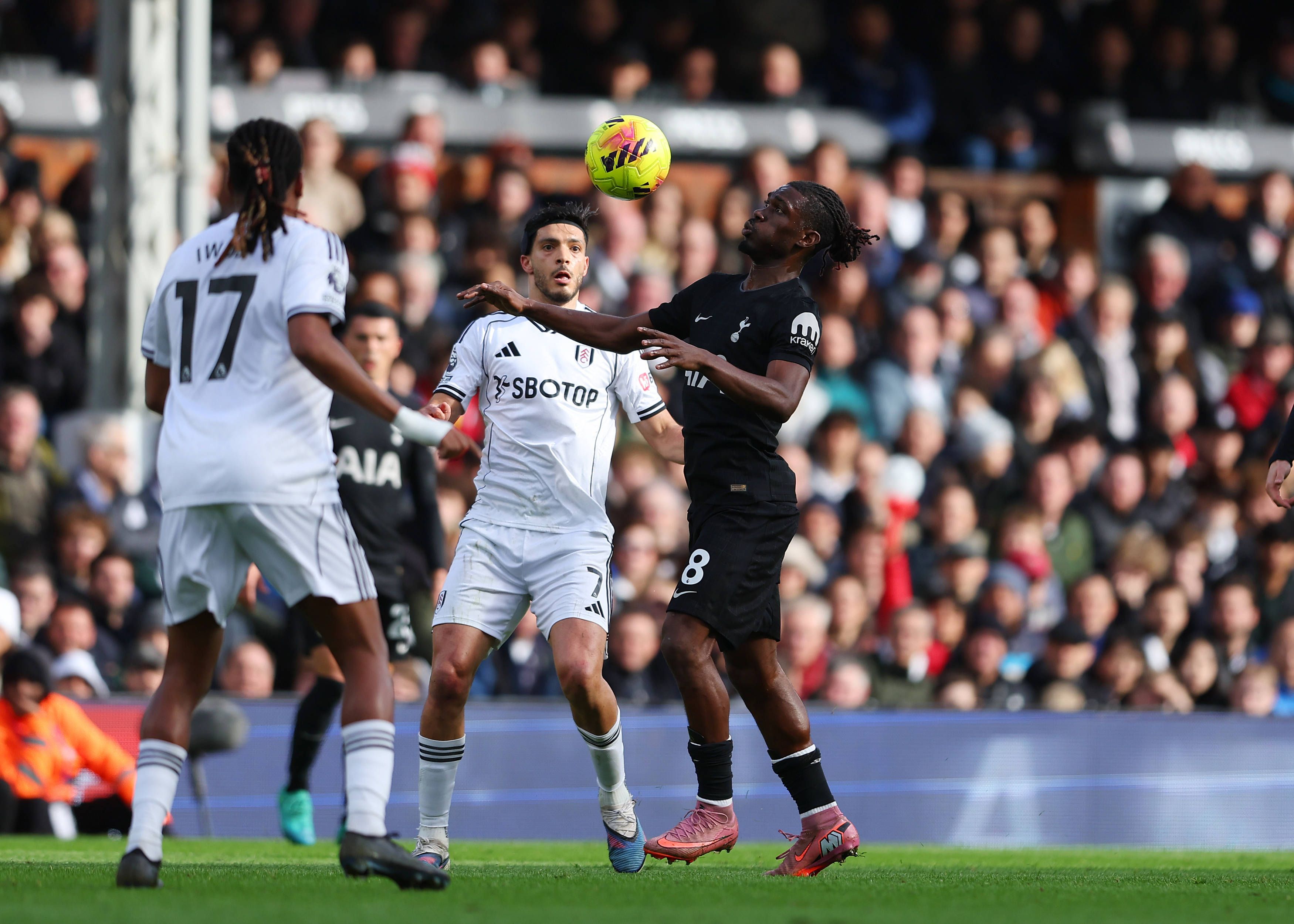 Yves Bissouma closely marked by Alex Iwobi