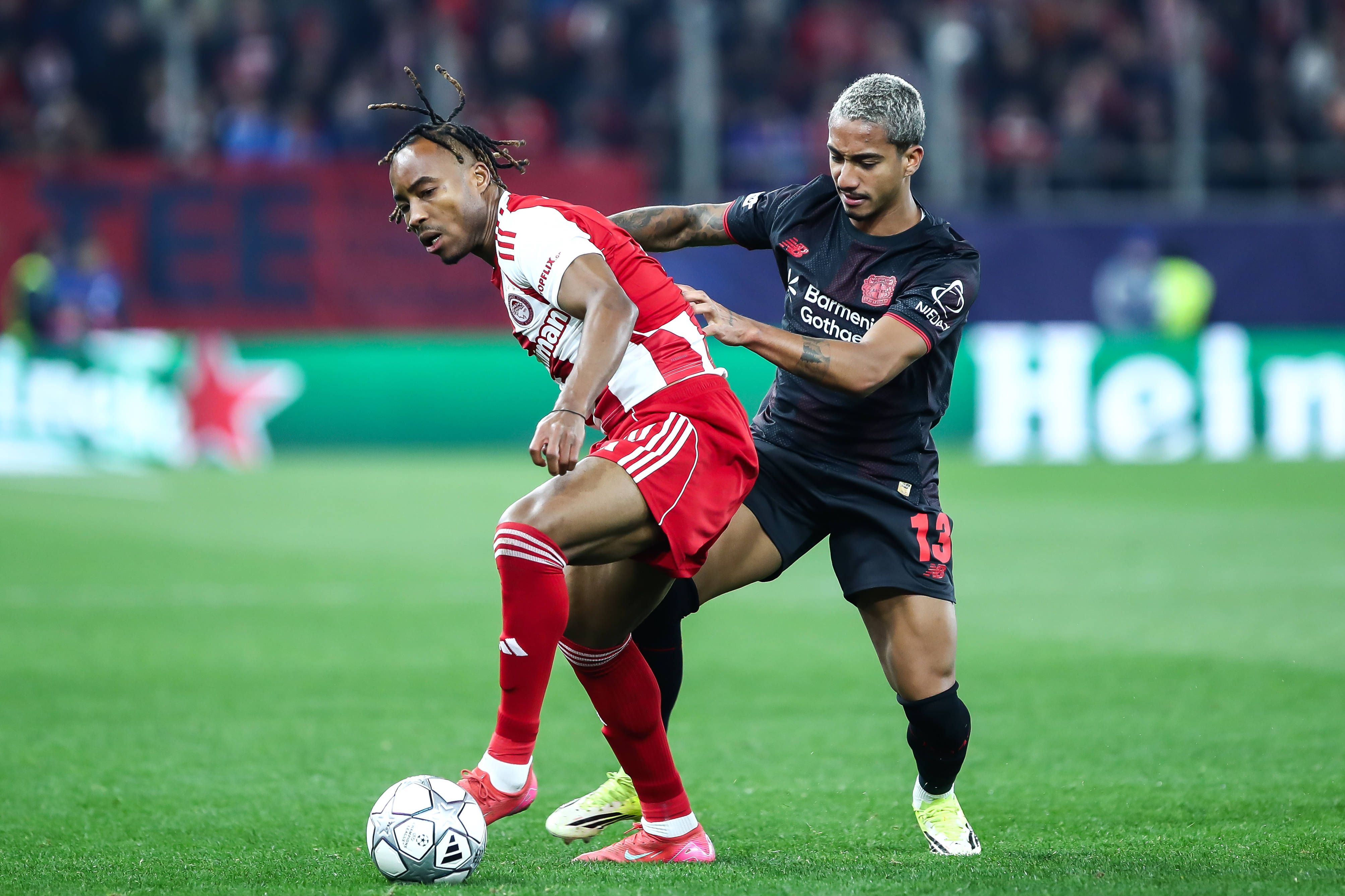 Arthur of Bayer 04 Leverkusen competes with Bruno Onyemaechi of Olympiacos