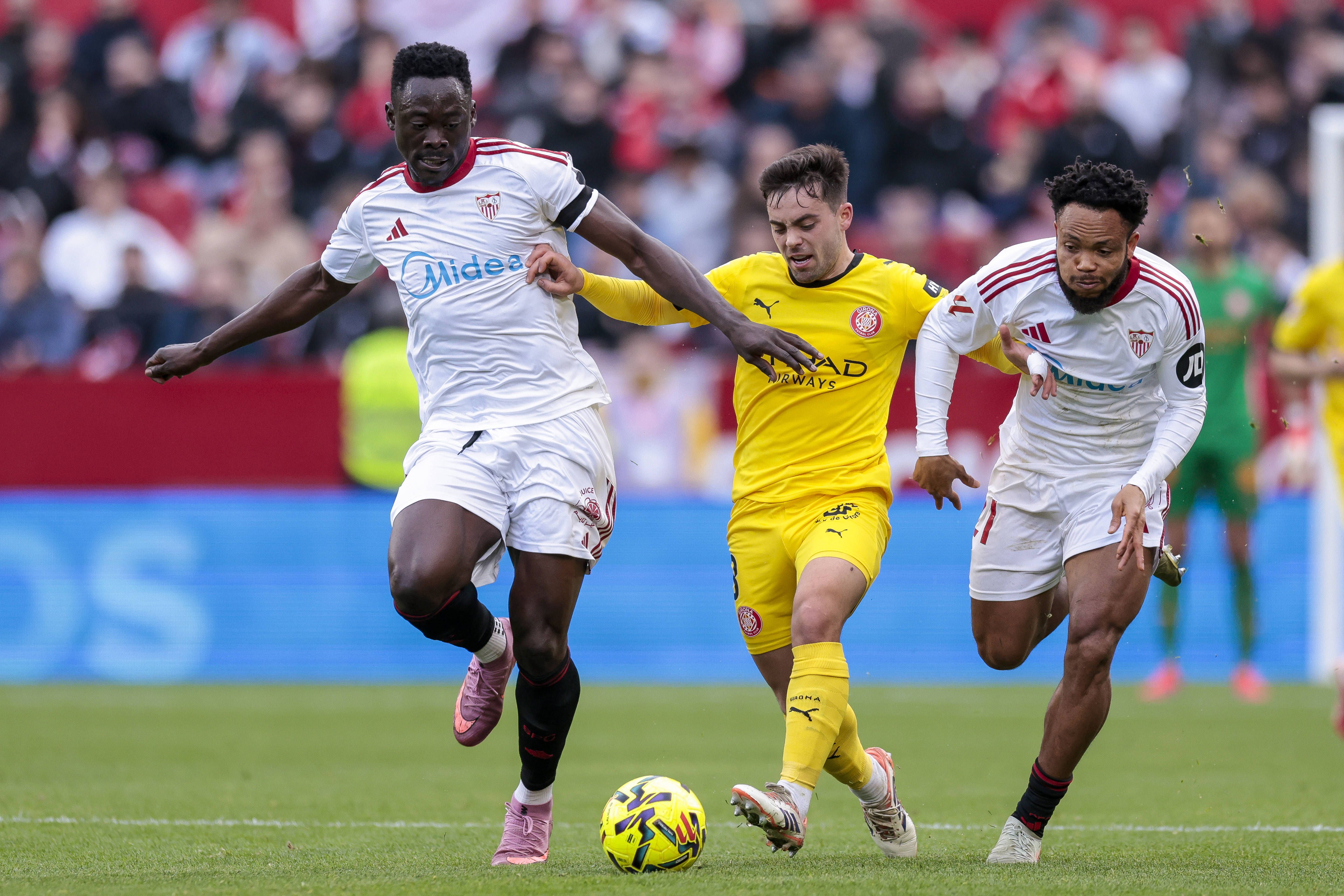 Fran Beltran of Girona FC competes for the ball with Akor Adams of and Ejuke