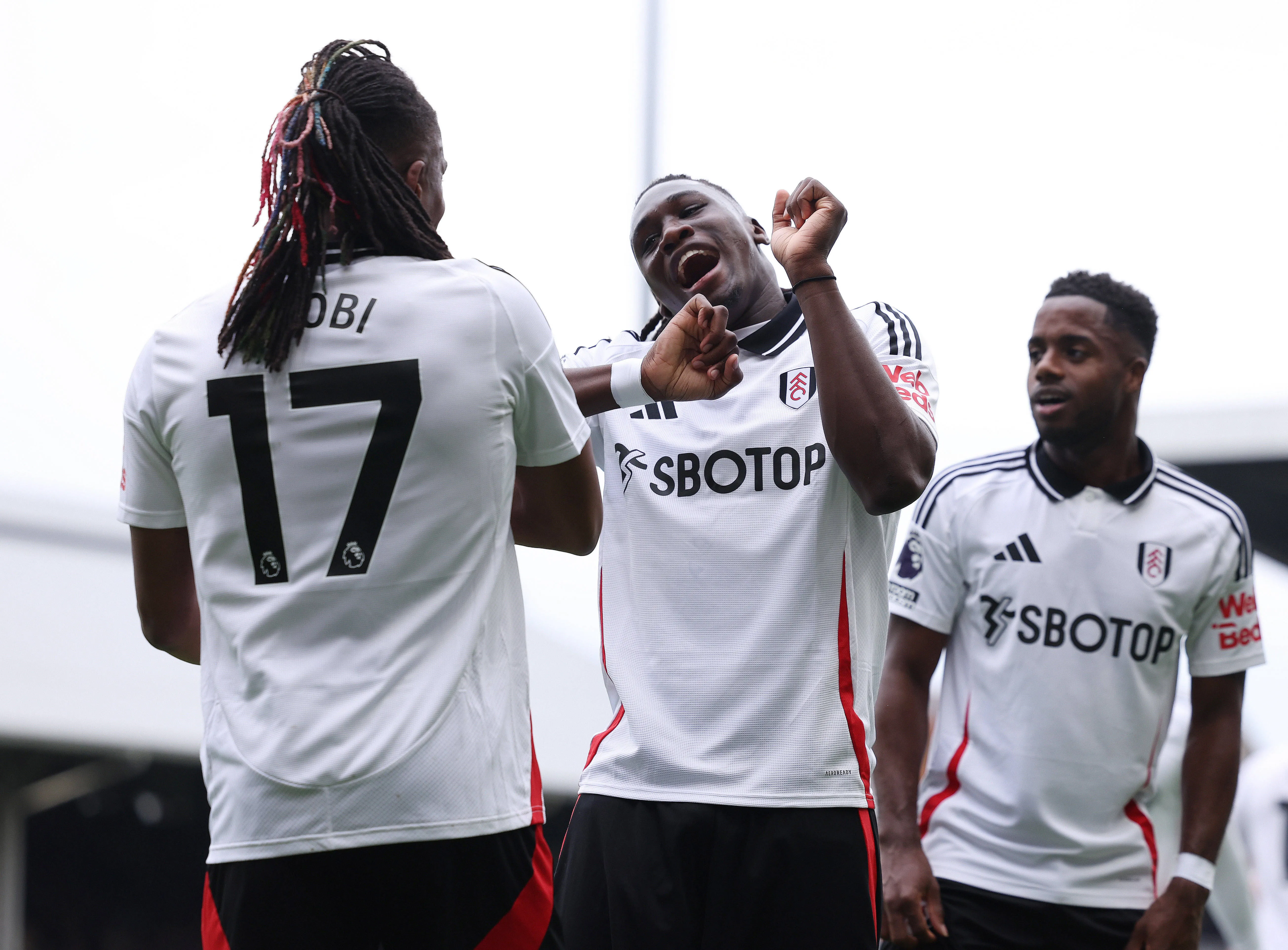 Alex Iwobi L of Fulham celebrates with Calvin Bassey of Fulham
