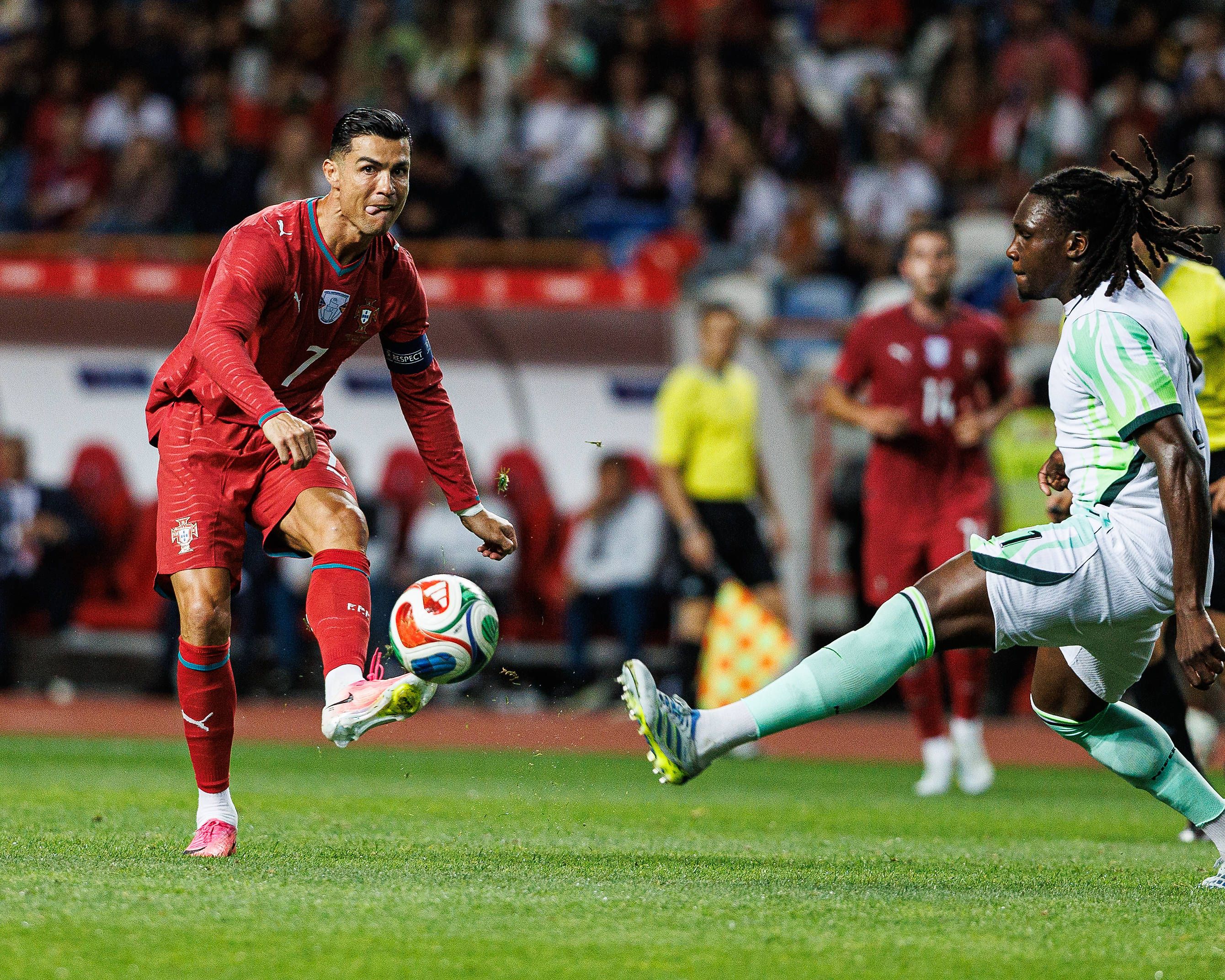 Cristiano Ronaldo of Portugal takes on Nigeria's Calvin Bassey