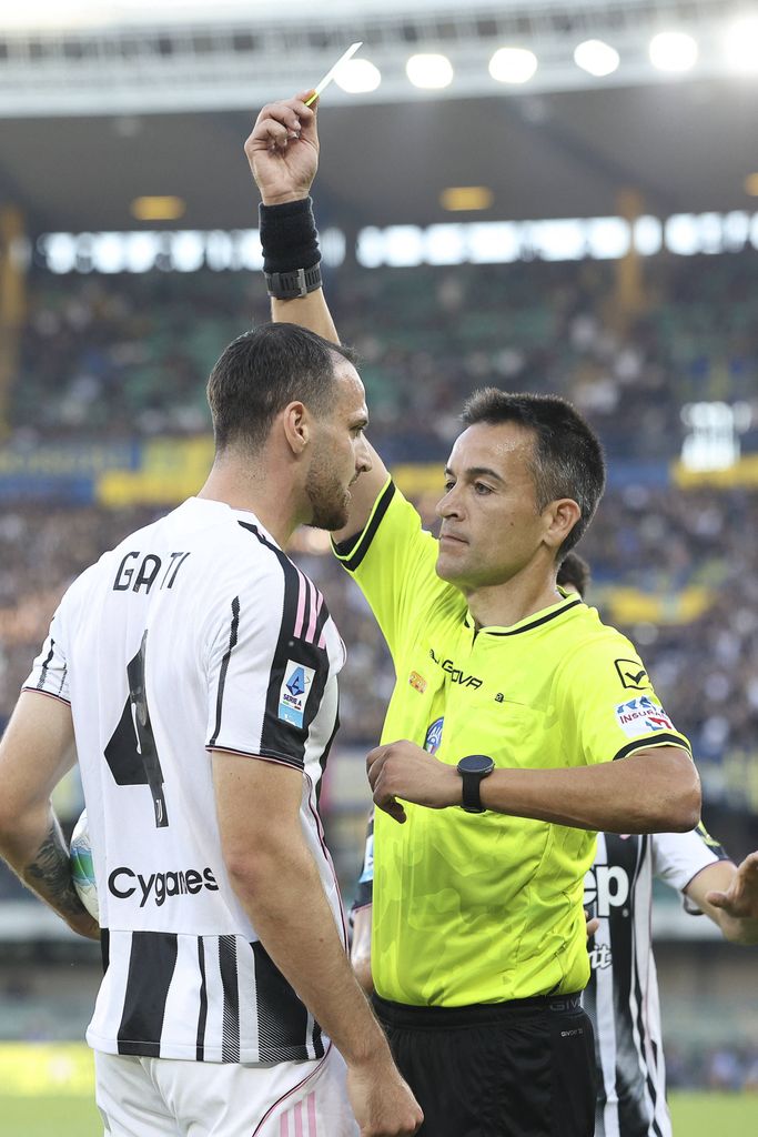  The Referee Antonio Rapuano shows the yellow card to Federico Gatti in Hellas Verona FC vs Juventus FC.