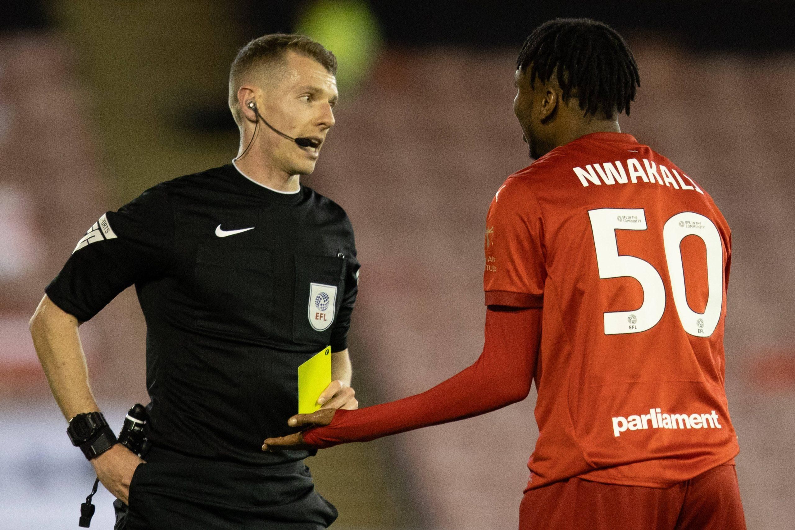 Ex Arsenal star Kelechi Nwakali of Barnsley is shown a yellow card