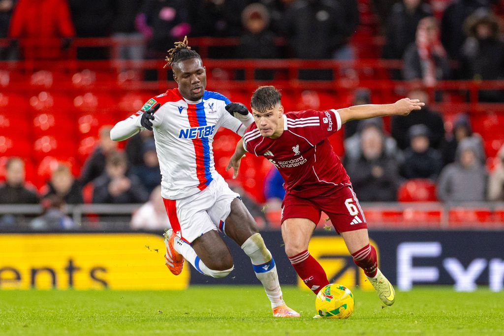 Milos Kerkez is challenged by Christantus Uche during the Football League Cup 4th Round match between Liverpool FC and Crystal Palace FC