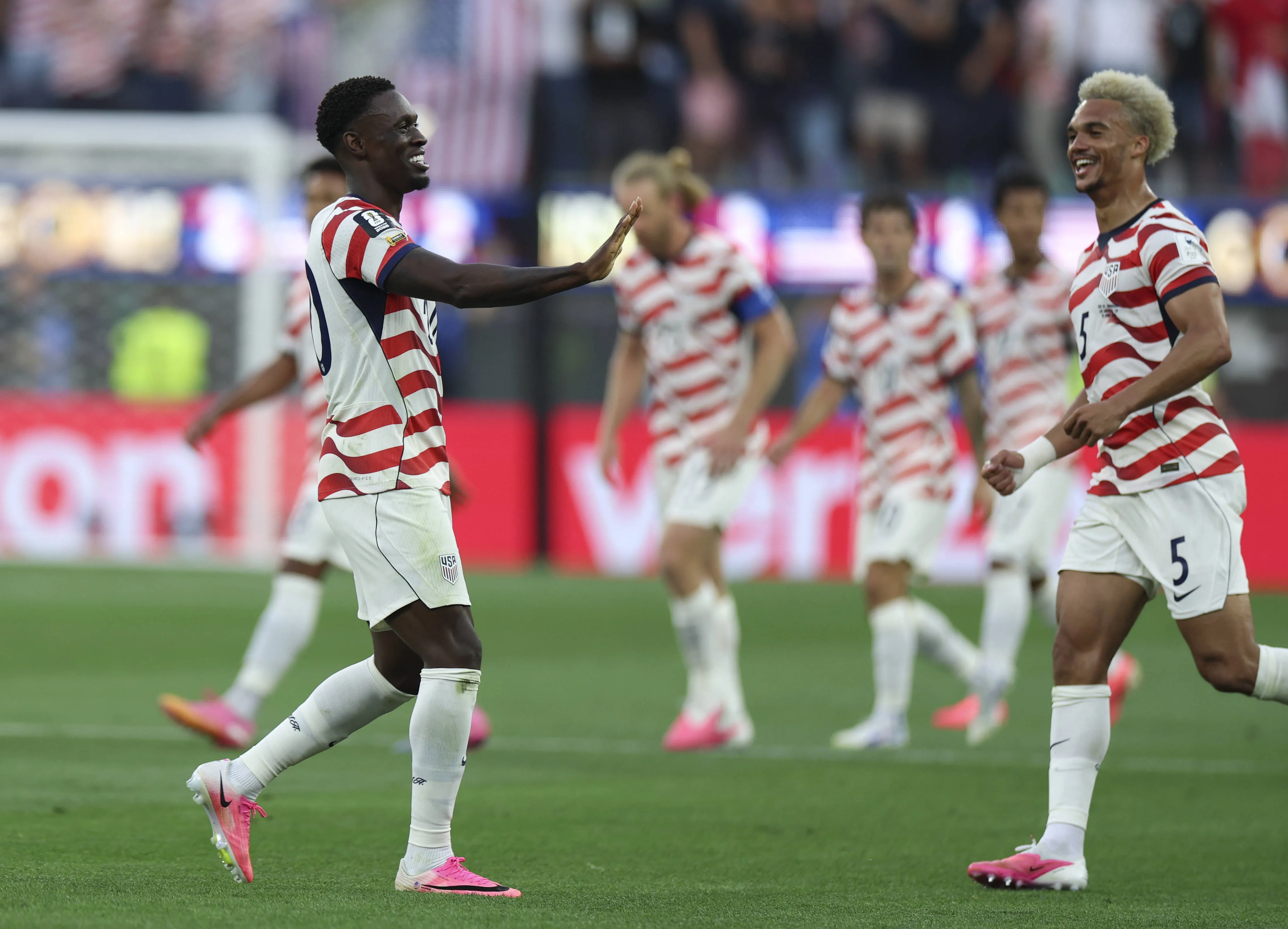 Folarin Balogun of the United States celebrates scoring with Antonee Robinson