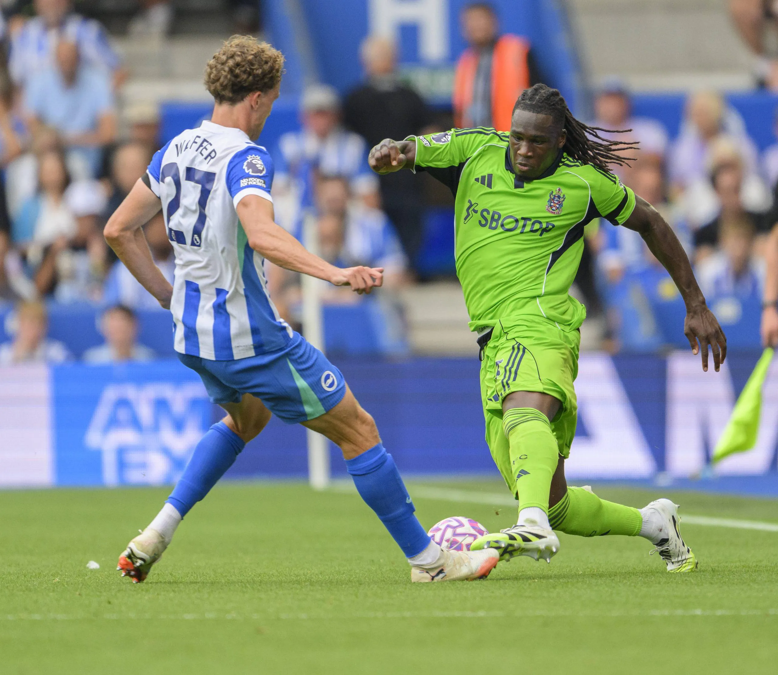 Calvin Bassey right battles with Brighton & Hove Albion's Mats Wieffer during the Premier League match between Brighton and Hove Albion and Fulham at the American Express Stadium