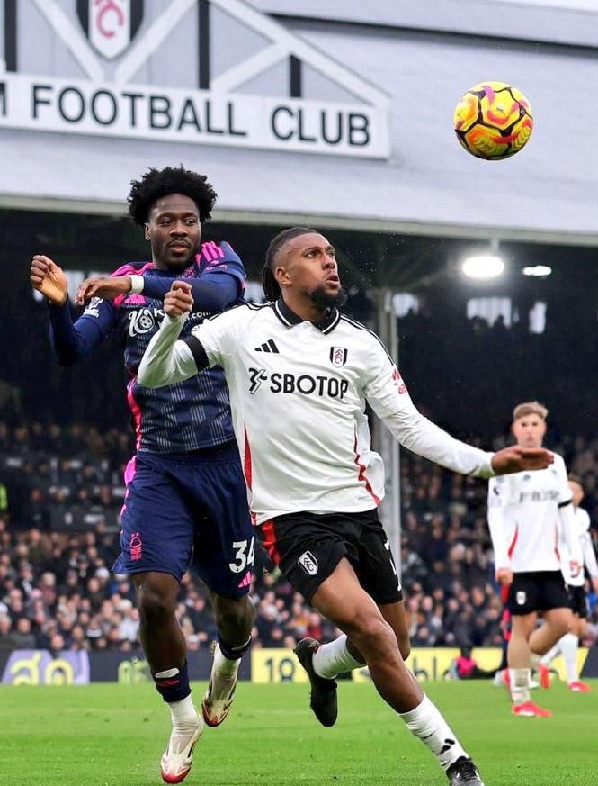 Nottingham Forest star Ola Aina challenges Fulham playmaker Alex Iwobi.