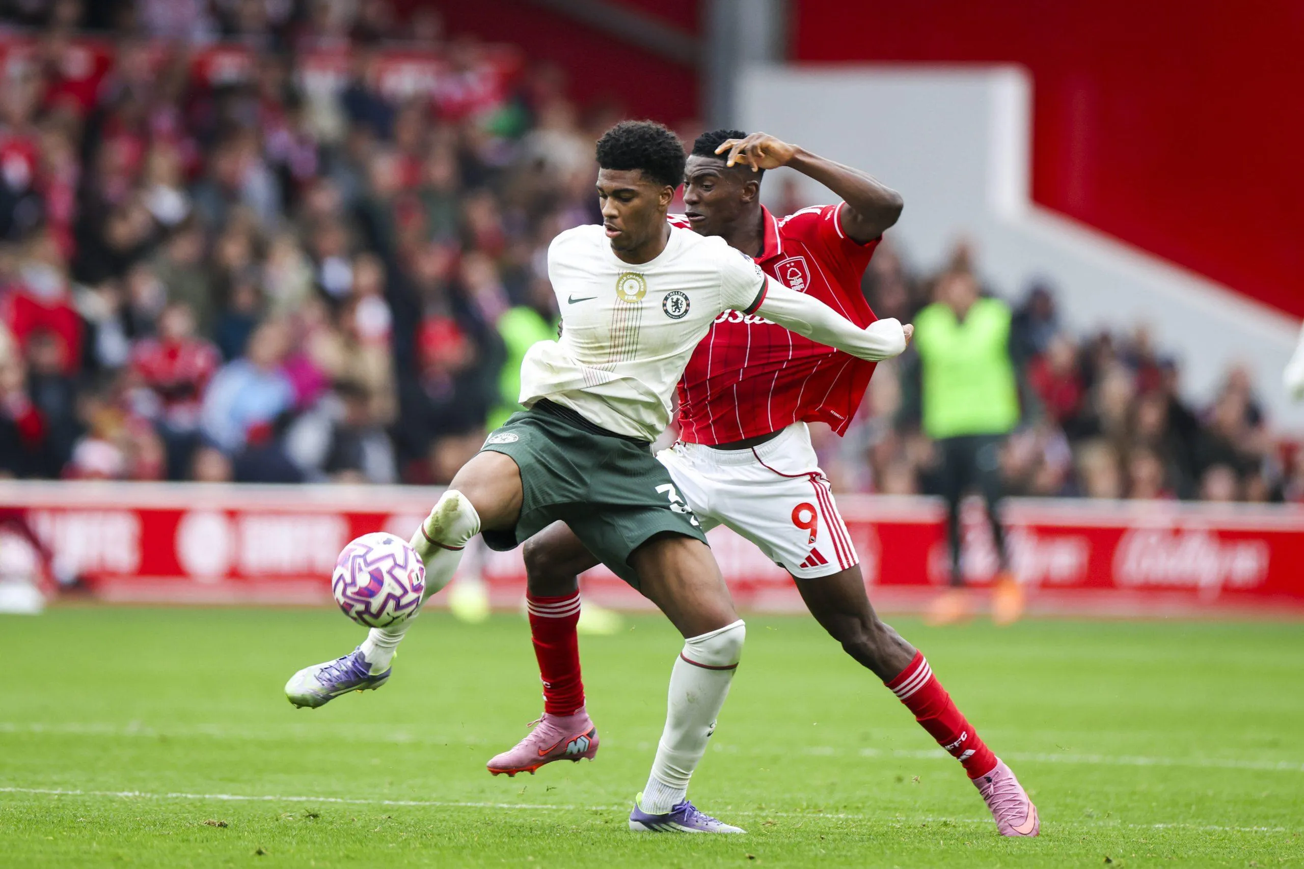 Josh Acheampong battles Taiwo Awoniyi during the Nottingham Forest v Chelsea