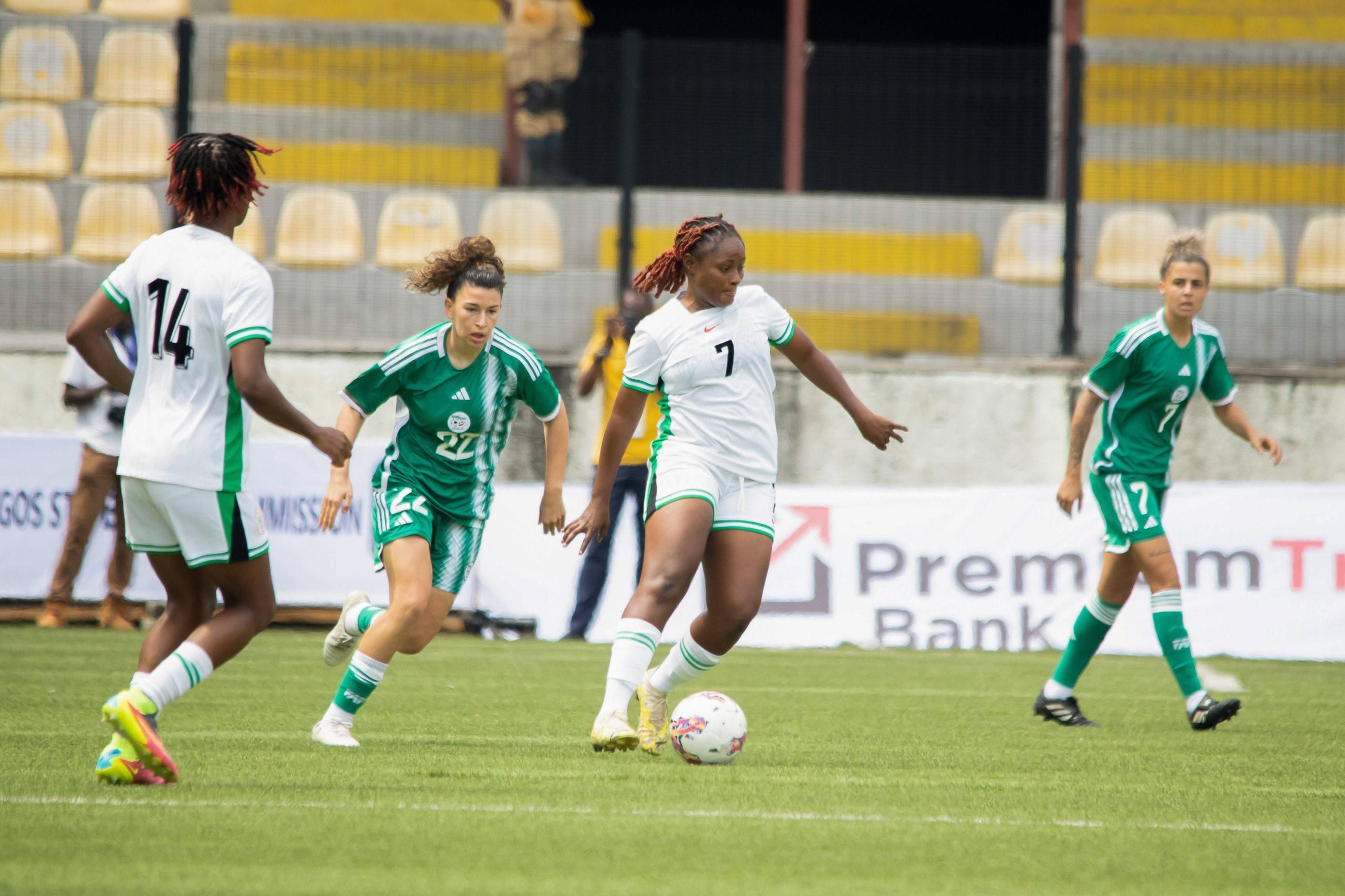 Mathias Josephine of Nigeria and Algeria defenders during an international friendly match between the Nigeria Super Falcons and Algeria Green Ladies