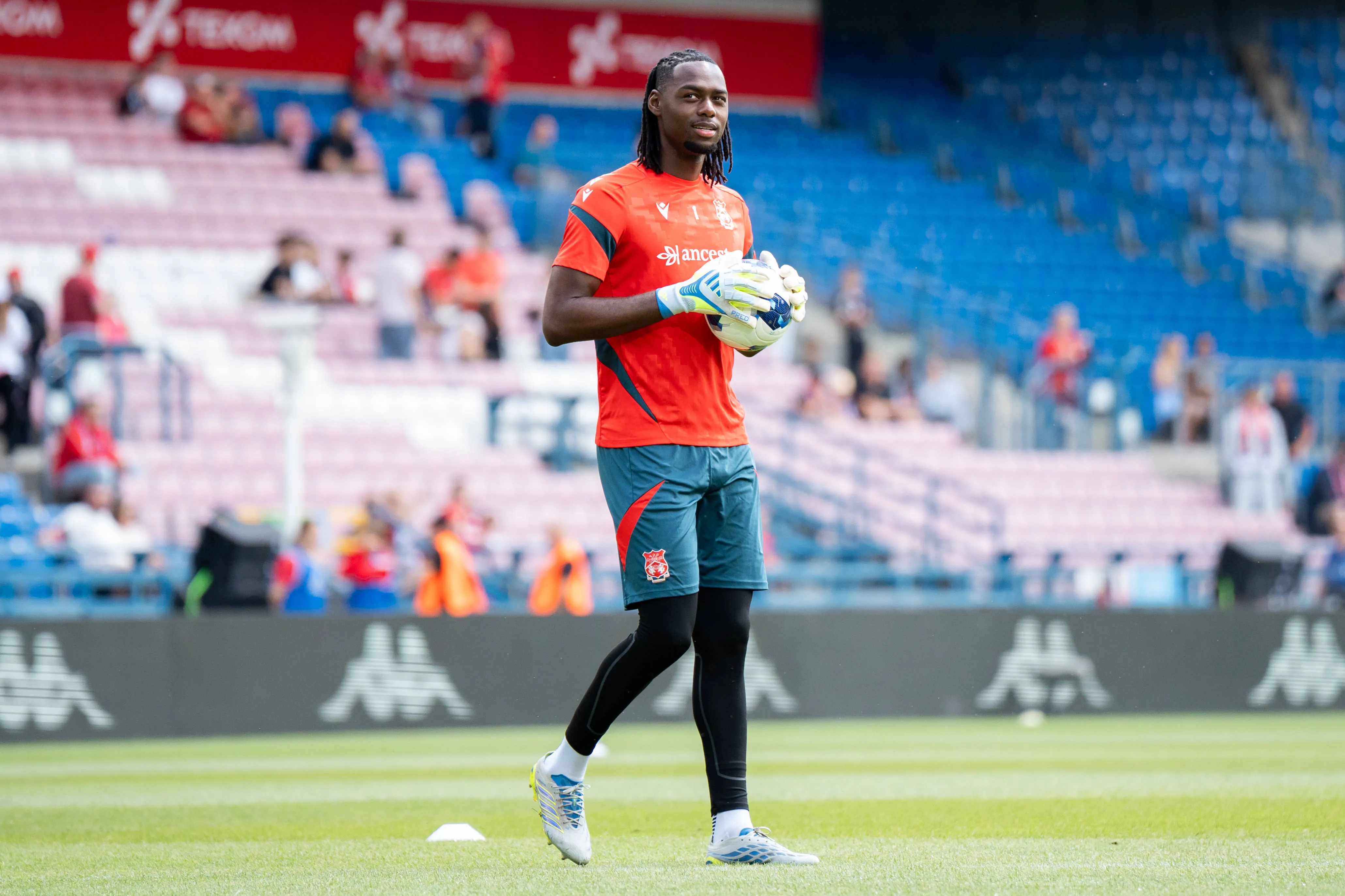 Wrexham Goalkeeper Arthur Okonkwo warms up