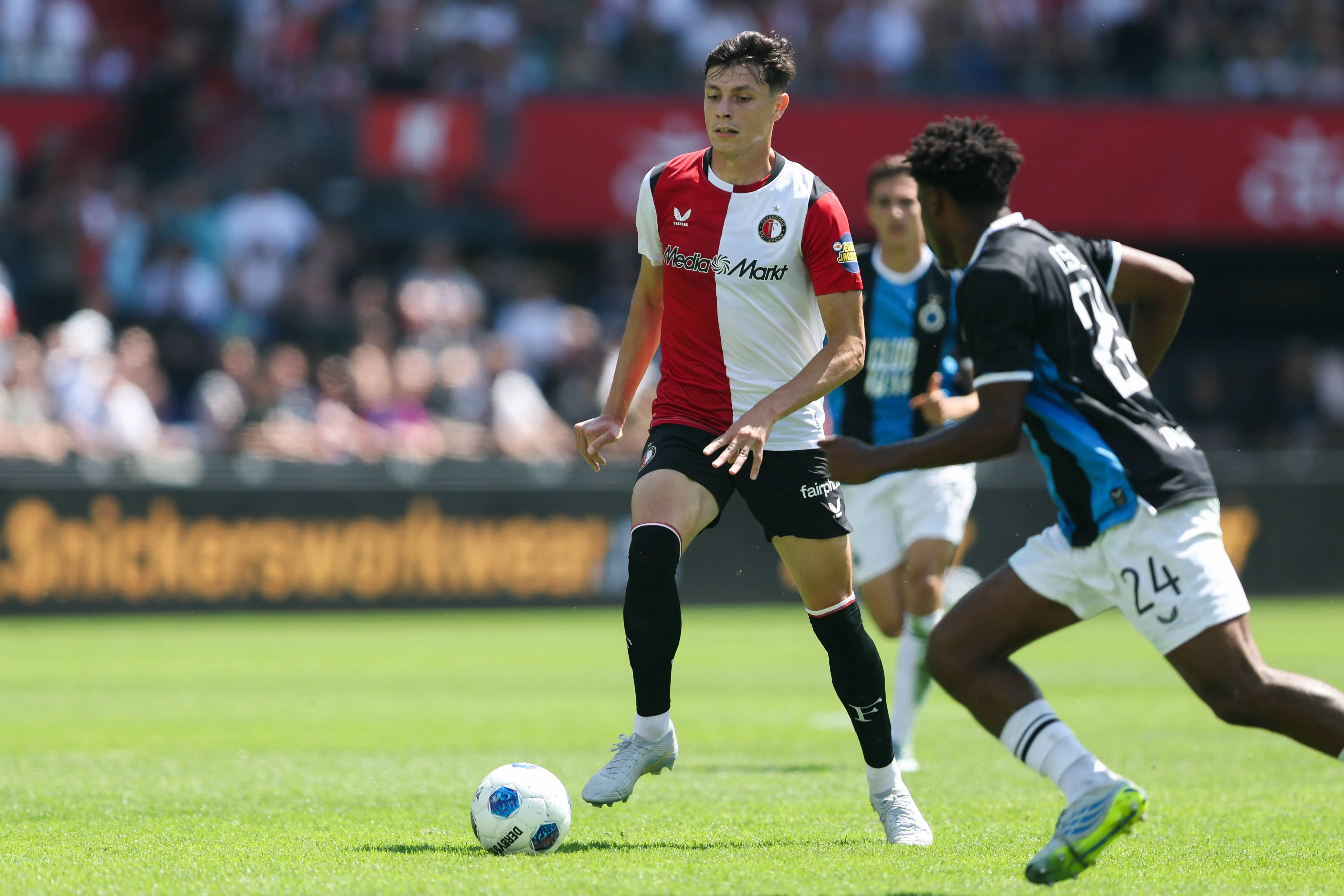 Anel Ahmedhodzic of Feyenoord is challenged by Vince Osuji