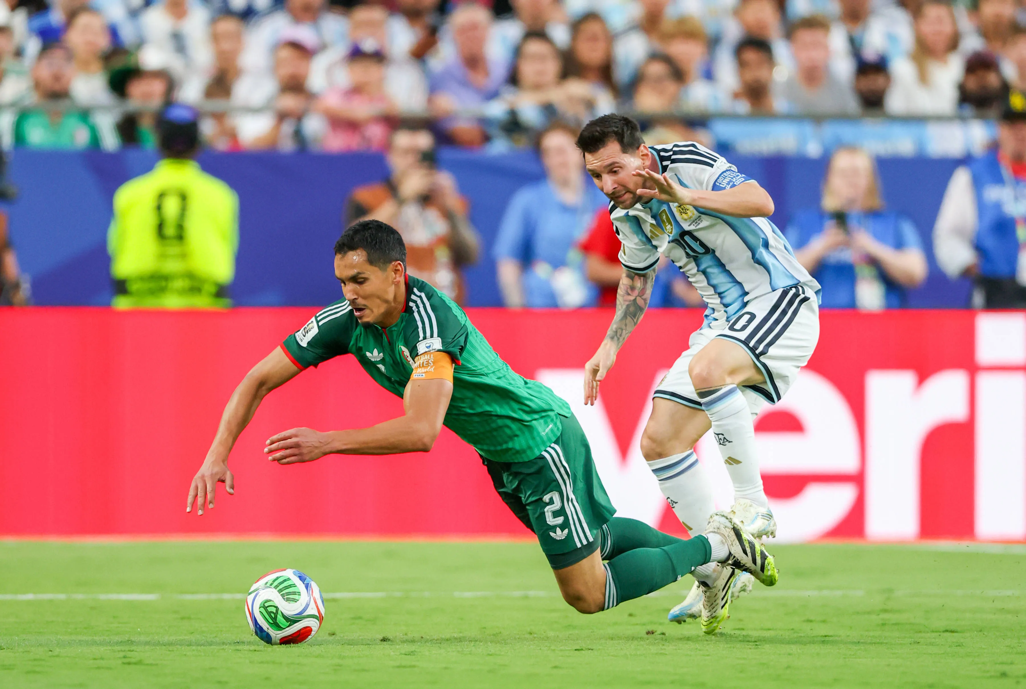 Lionel Messi commits a foul against Algeria defender Aissa Mandi