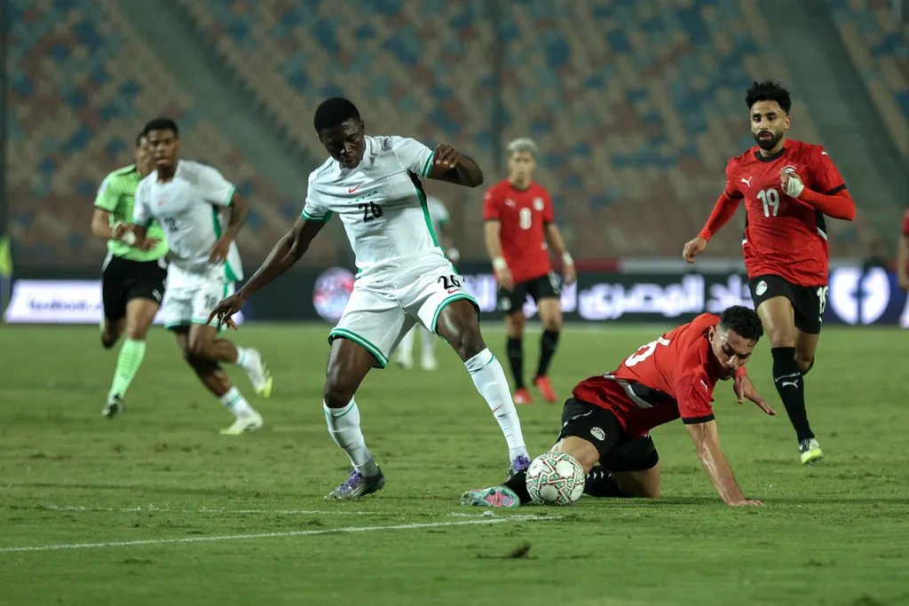 Mohamed Hany is in action with Super Eagles Ebenezer Akinsanmiro