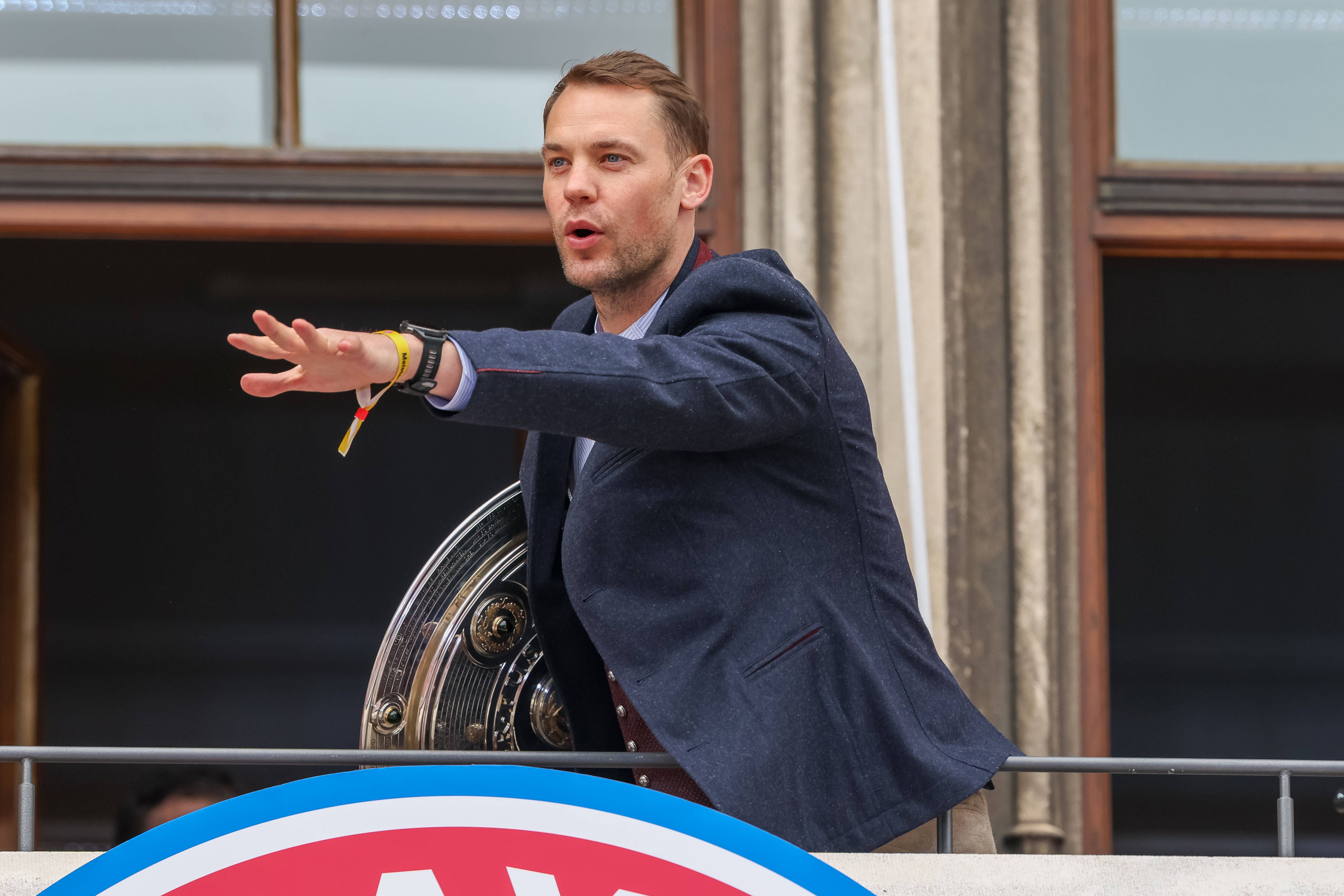 Manuel Neuer of FC Bayern Muenchen with the championship trophy on the town hall balcony at Marienplatz, Germany
