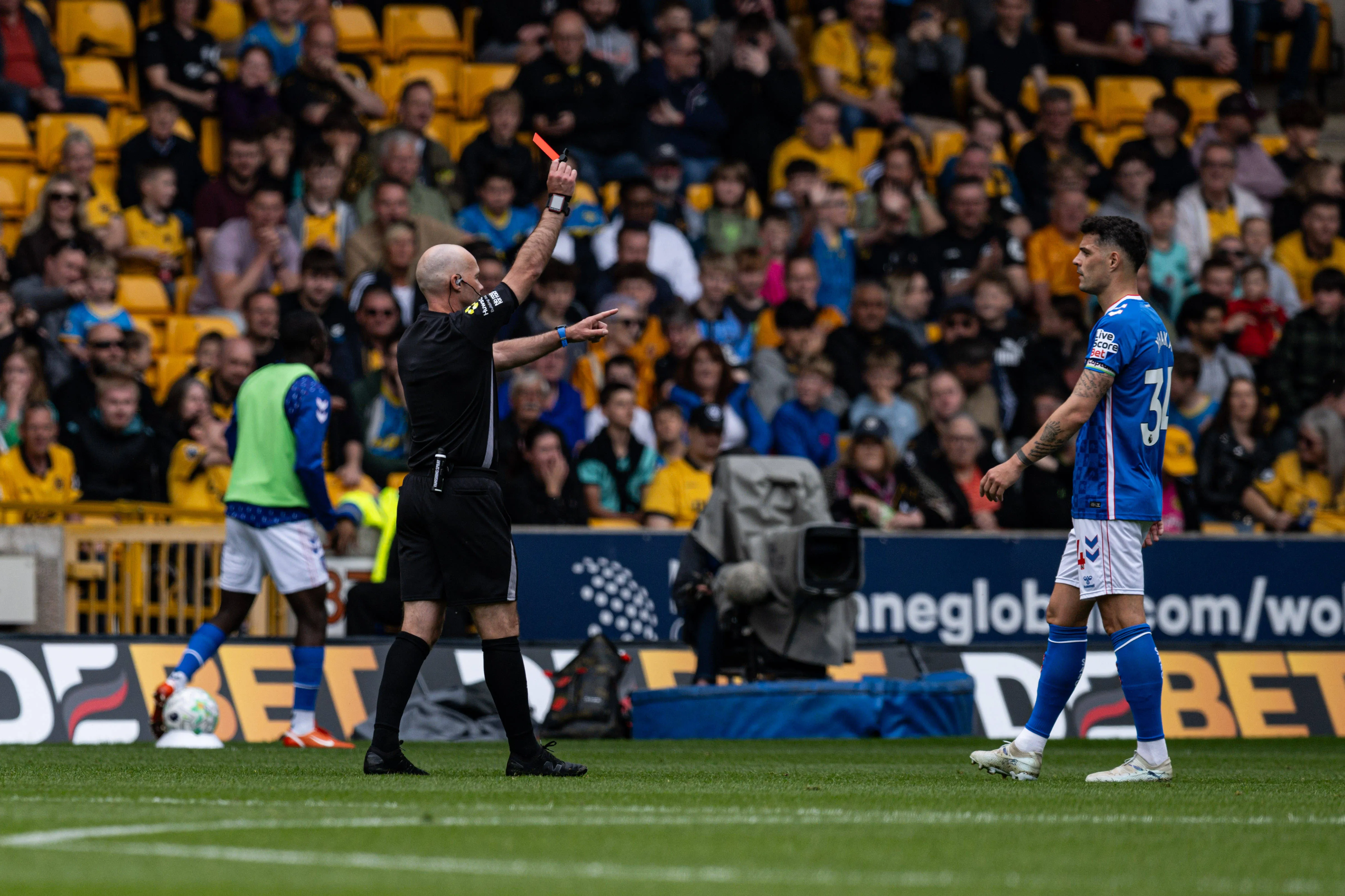 Referee Paul Tiernery issues a red card to Daniel Ballard of Sunderland for violent conduct during a Premier League clash with Wolves