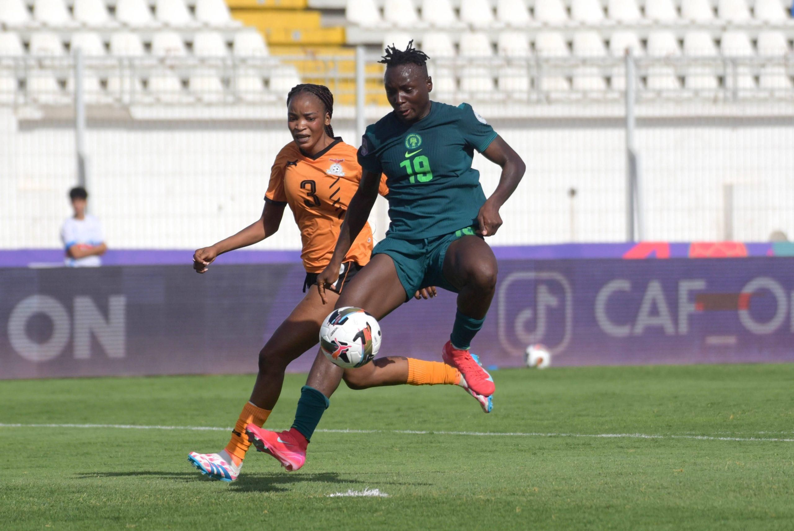 Chinwendu Ihezuo of Nigeria and Lushomo Mweemba of Zambia in action for their countries