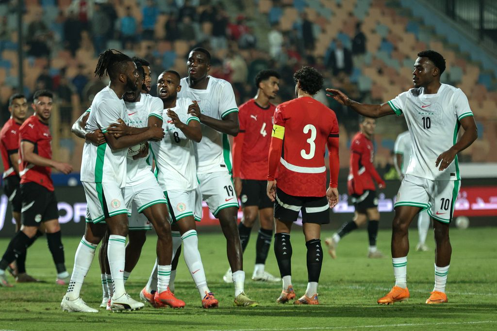 Nigeria's players celebrate scoring their first goal with teammates against Egypt