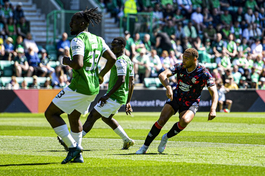 Cyriel Dessers scores their side's first goal of the match and reels away in celebration during the William Hill Premiership match at Easter Road