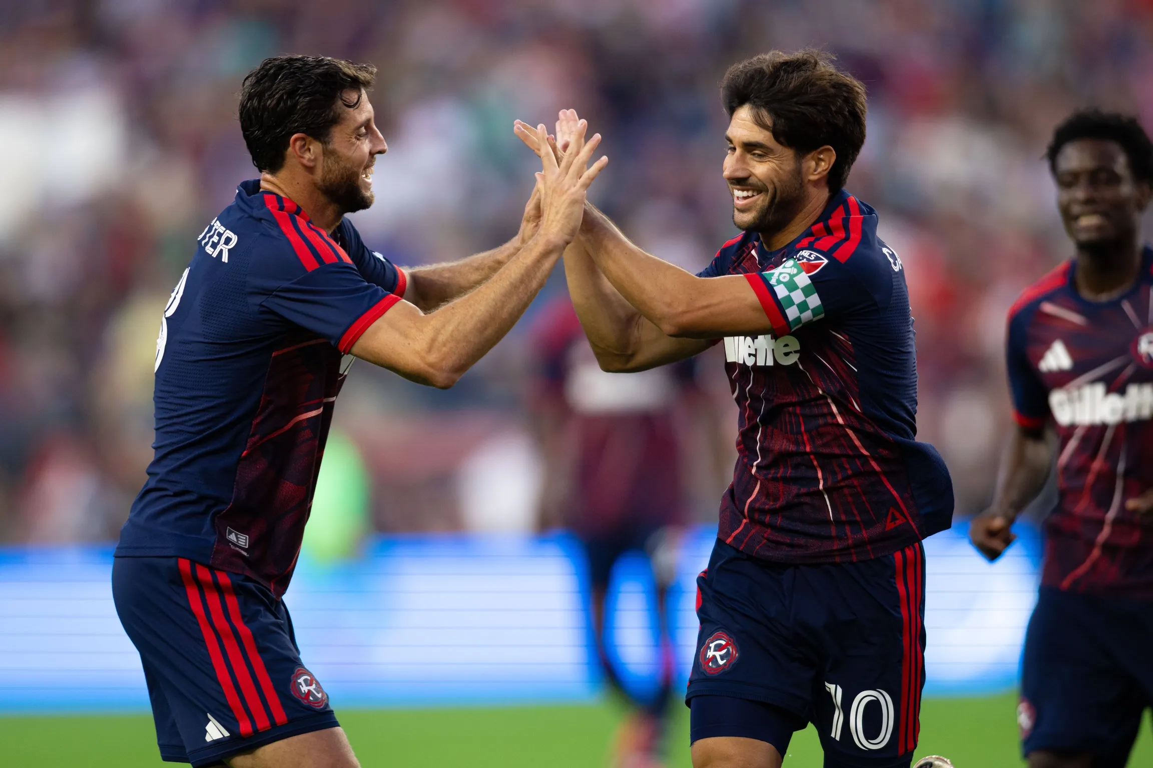 Matt Polster and Carles Gil celebrate a goal