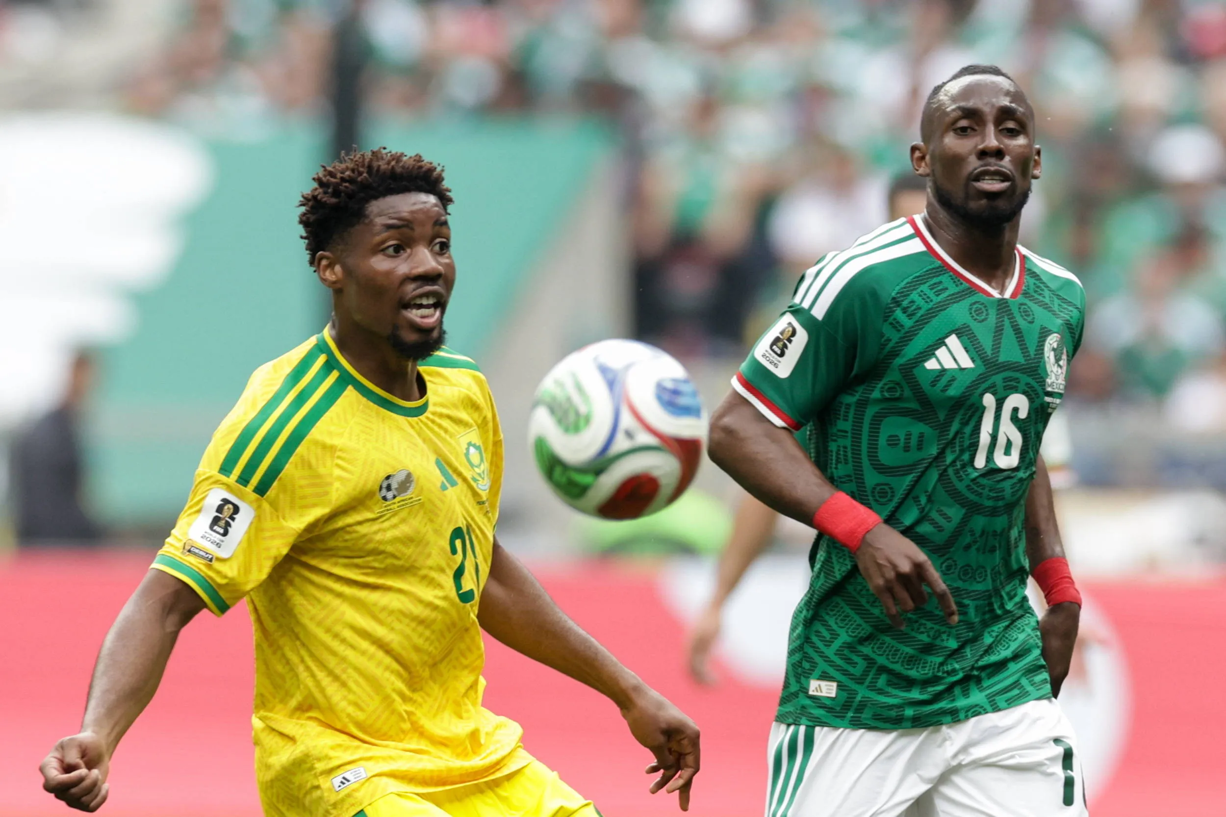 Ime Okon and Julian Quinones fight for the ball in the 2026 FIFA World Cup football match between Mexico and South Africa