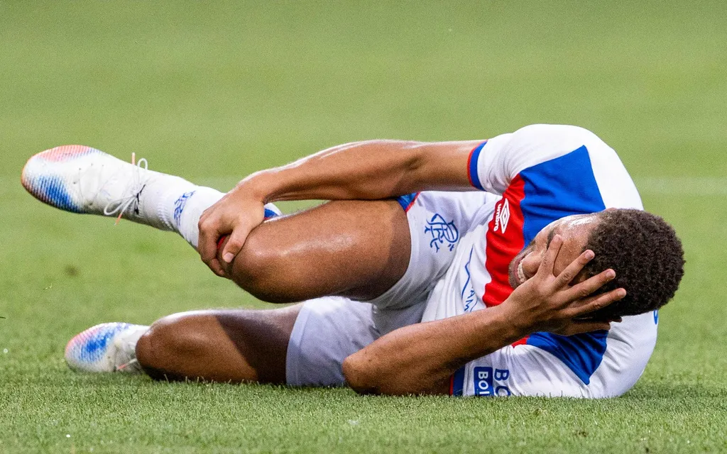 Cyriel Dessers looked in pain as he was helped from the pitch with what appeared to be a suspected knee injury
