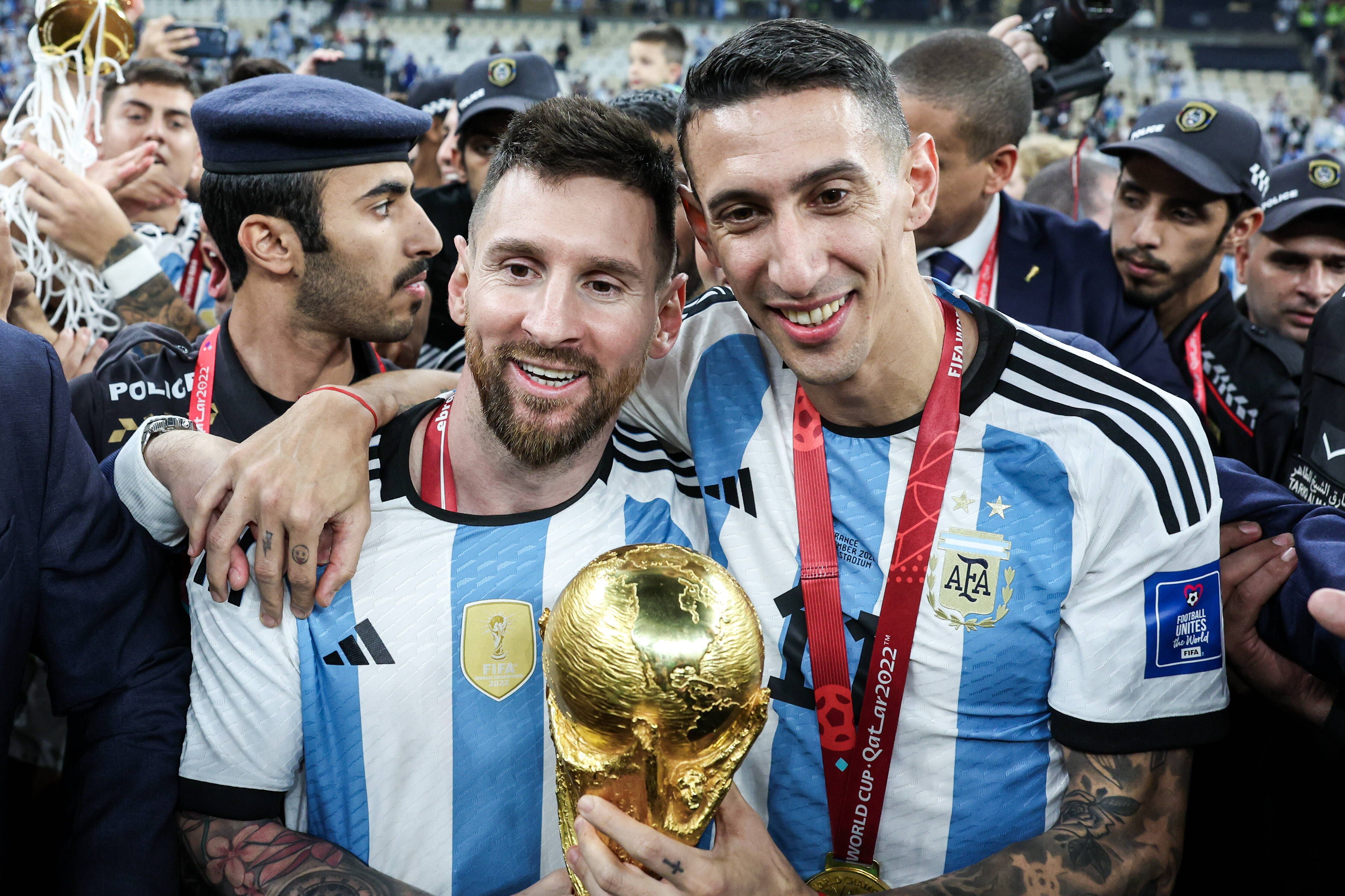  Argentina captain Lionel Messi and Angel di Maria pose with the trophy 