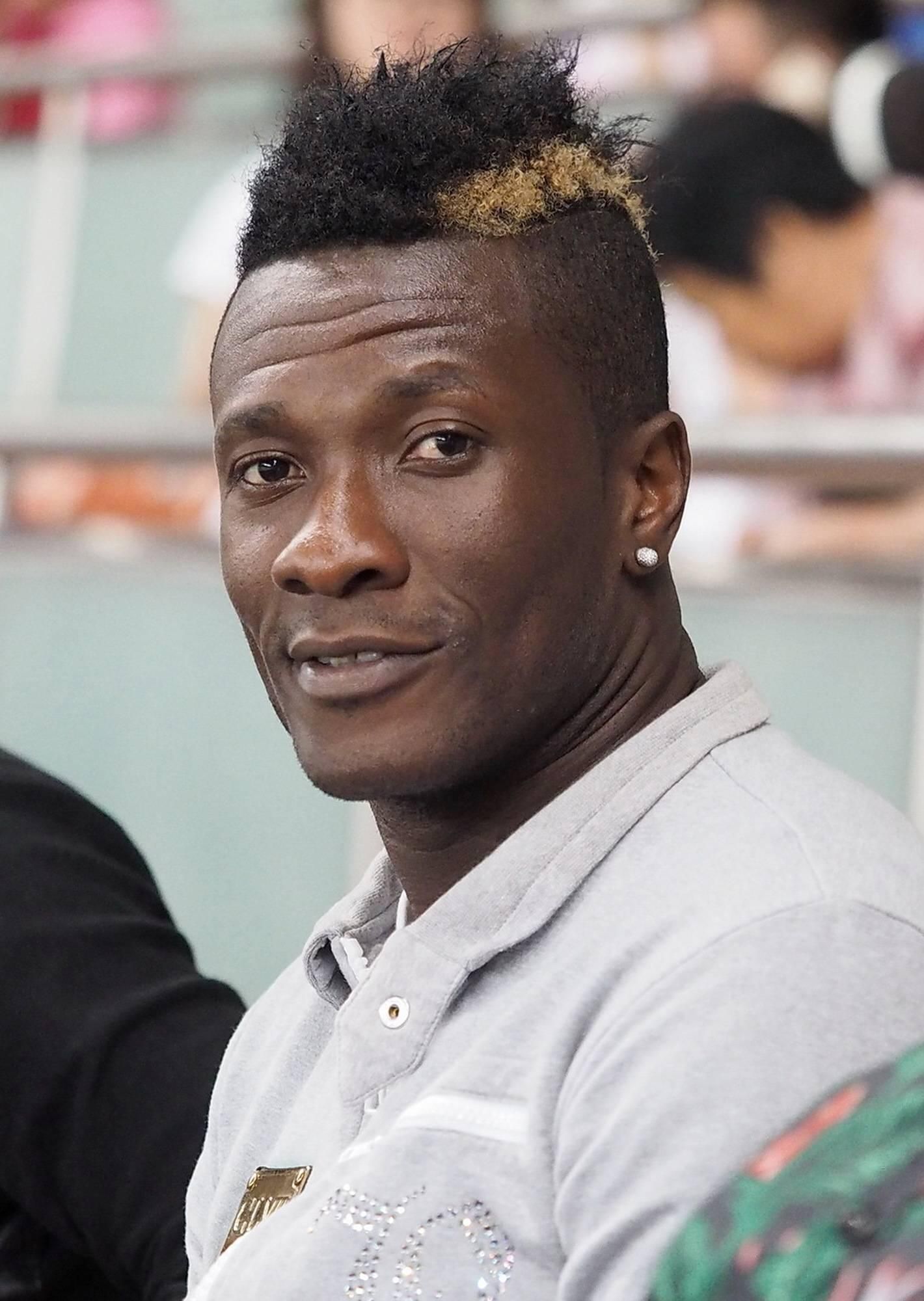 Ghana's striker Asamoah Gyan watches from the stand