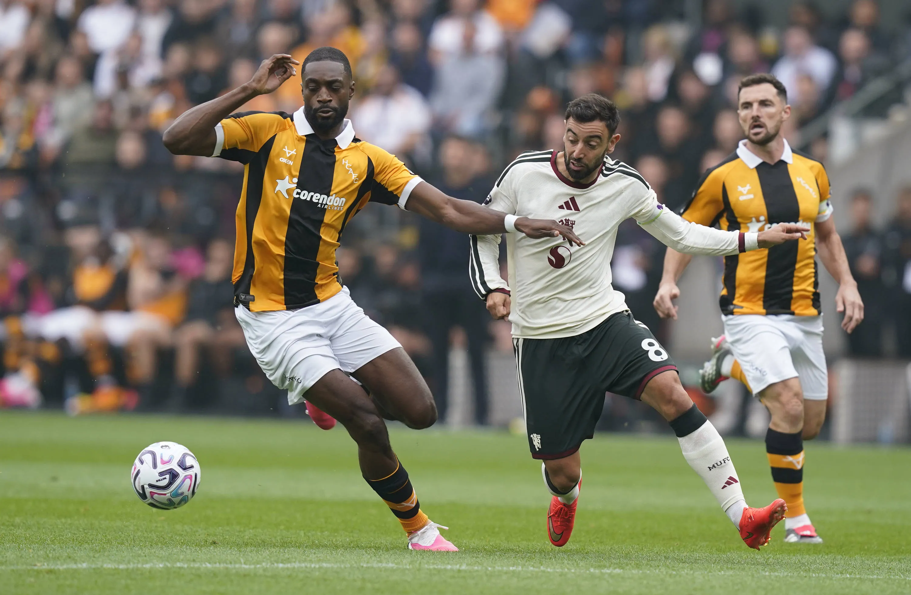 Semi Ajayi of Hull City L holds off Bruno Fernandes of Manchester United. 