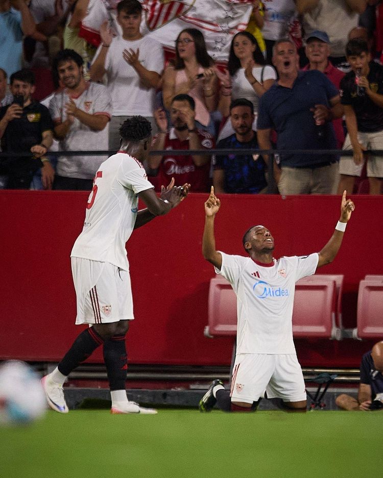 Sevilla forward Akor Adams celebrates with teammate Stanis Idumbo 