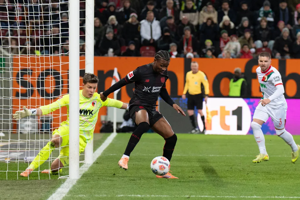 Nathan Tella and Finn Dahmen in action at the Bundesliga match FC Augsburg Bayer 04 Leverkusen