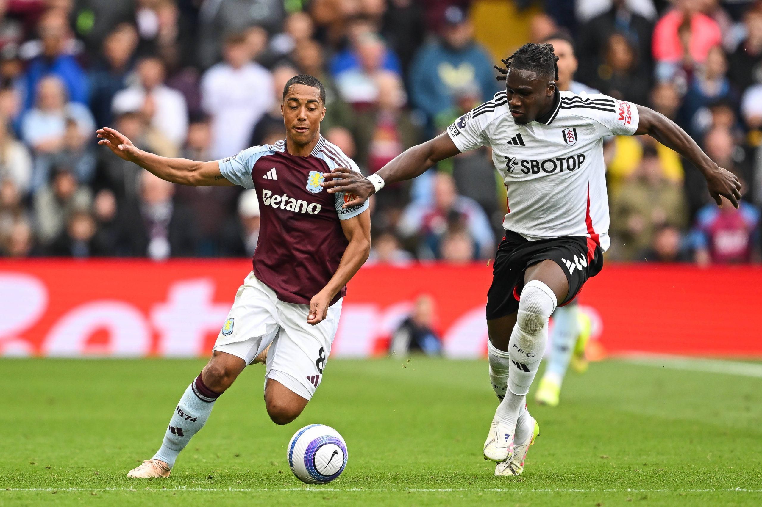 Youri Tielemans of Aston Villa battles for the ball with Calvin Bassey of Fulham 