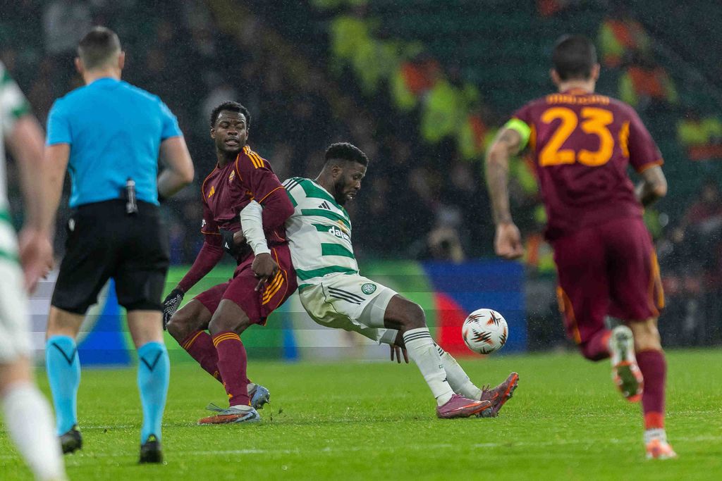 Kelechi Iheanacho goes down under the challenge of Evan Ndicka during the UEFA Europa League 2025/26 Matchday 6. Celtic FC vs AS Roma