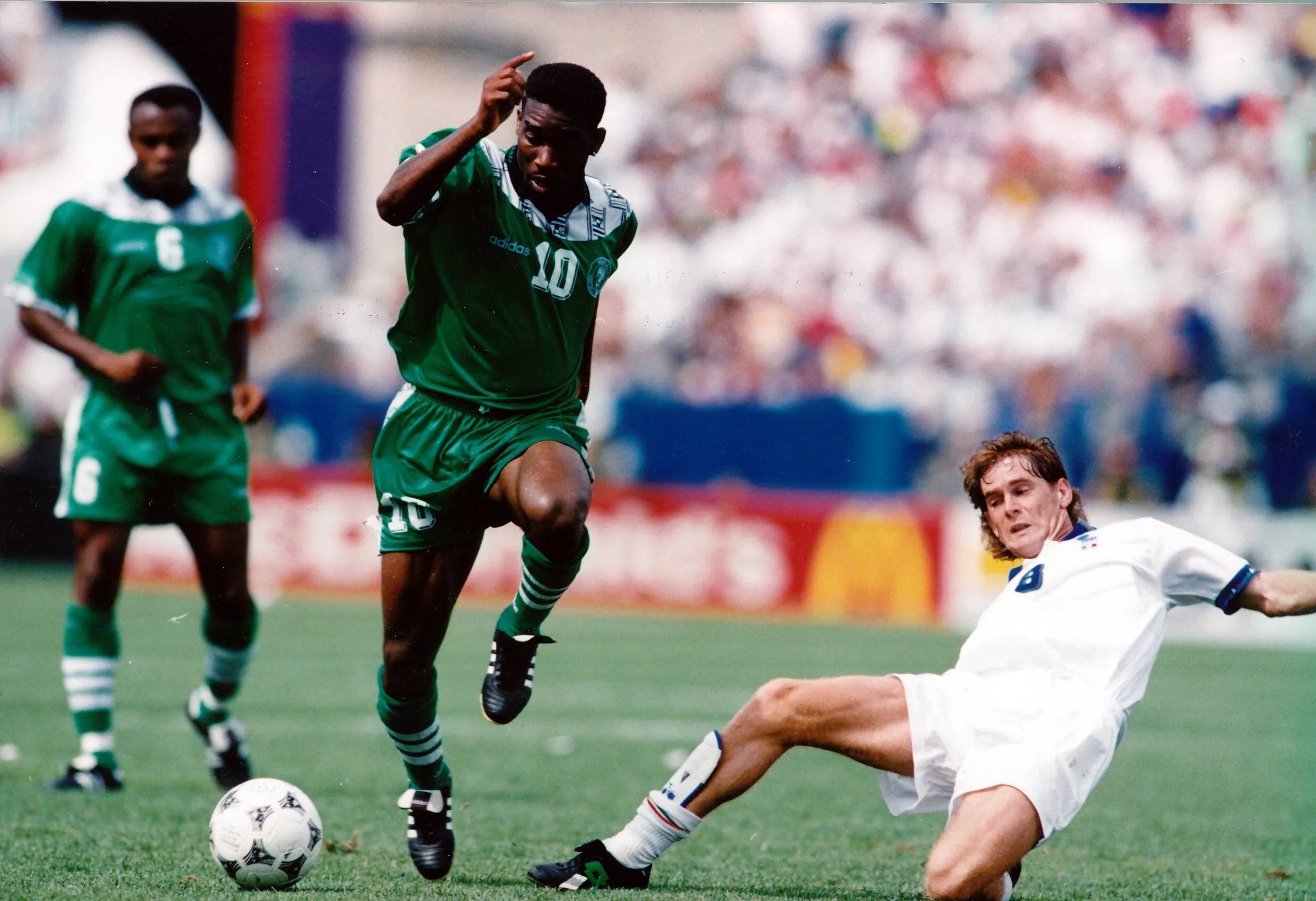 Jay Jay- Okocha goes past Roberto Mussi of Italy in the 1994 FIFA World Cup