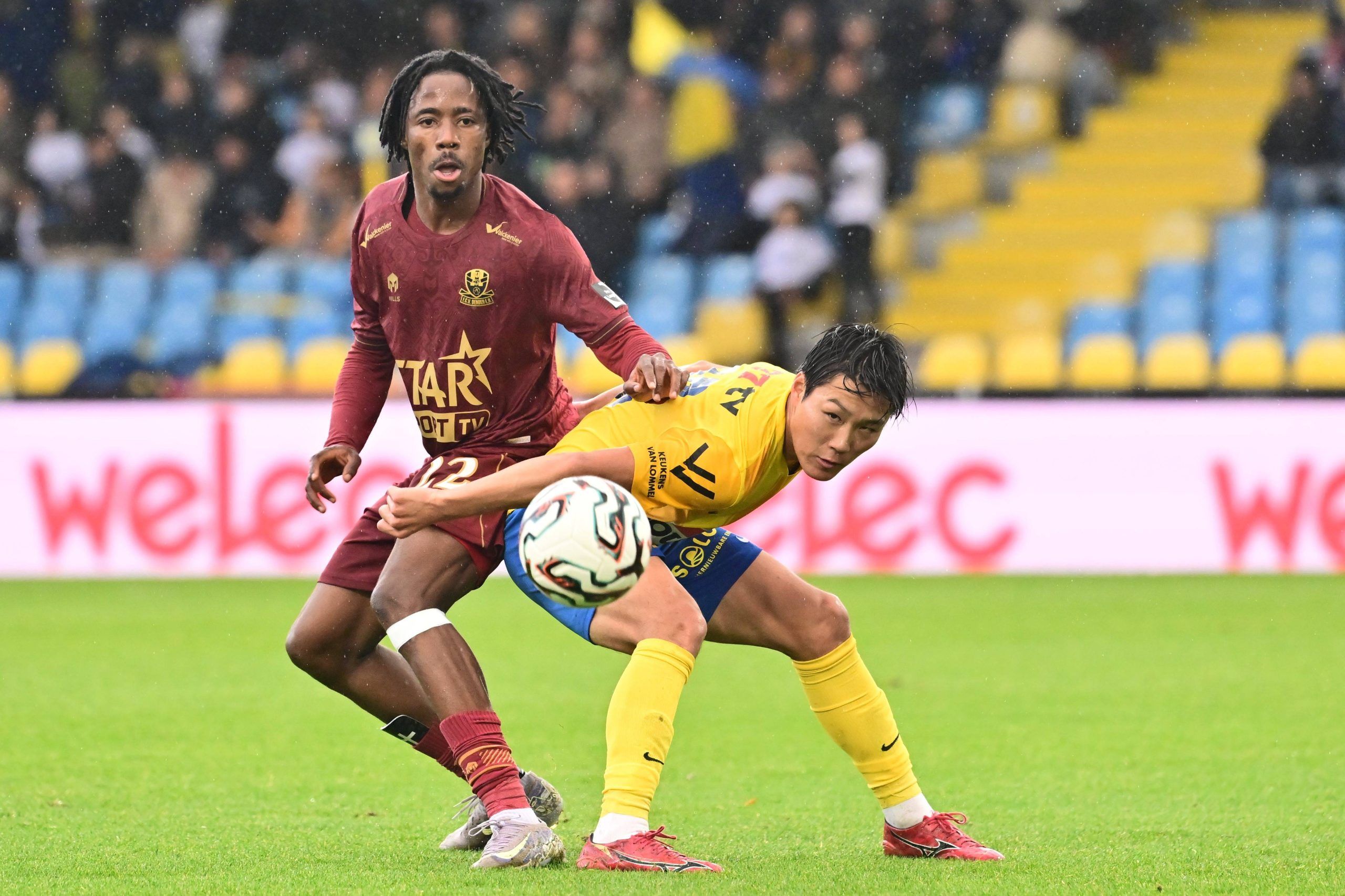 Sakamoto Isa Fredrick Benjamin Chiemela defender of Dender battle for the ball during a Jupiler Pro League match
