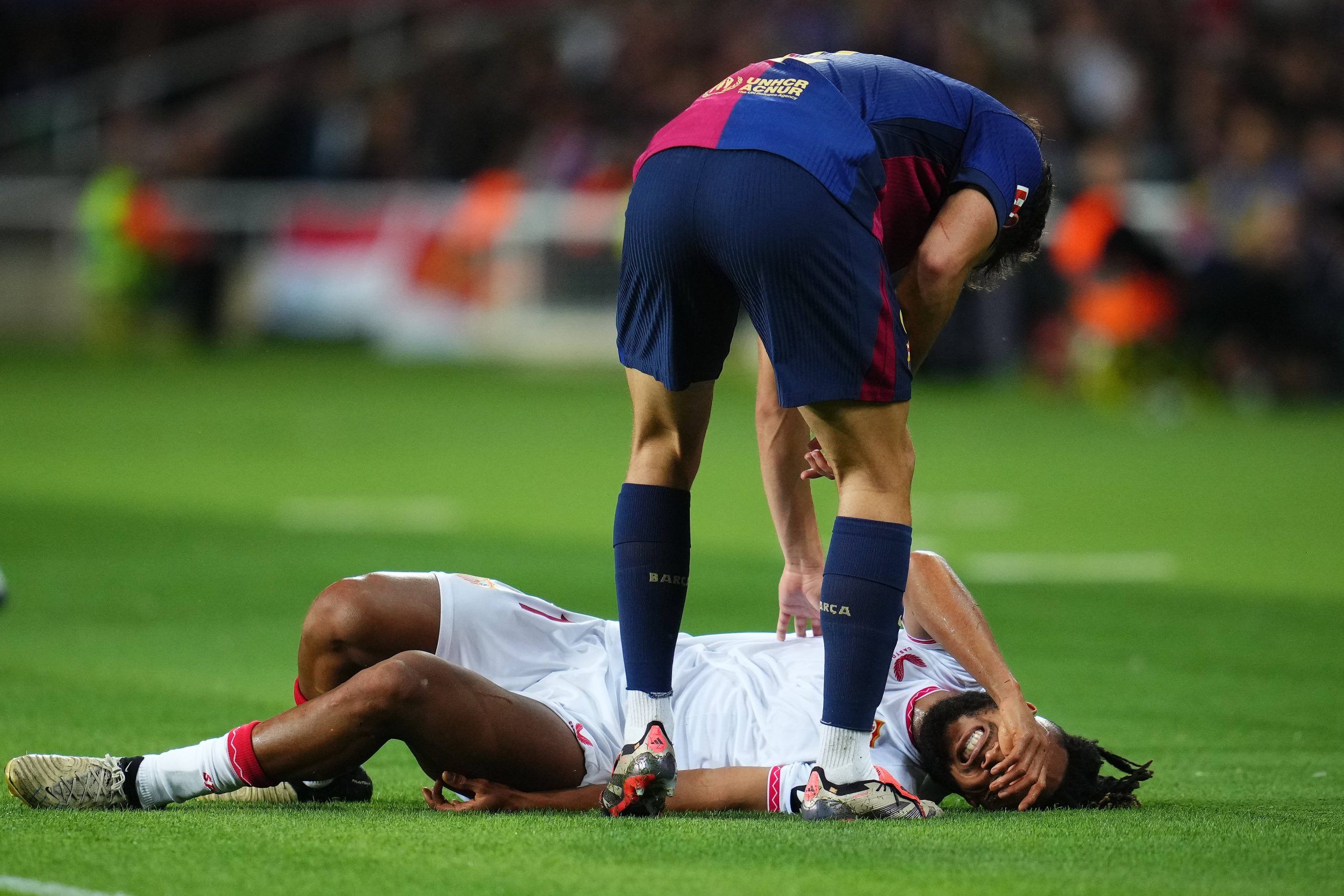 Chidera Ejuke of Sevilla FC injury during the La Liga EA Sports match between FC Barcelona and Sevilla FC played at Lluis Companys Stadium on October 20, 2024