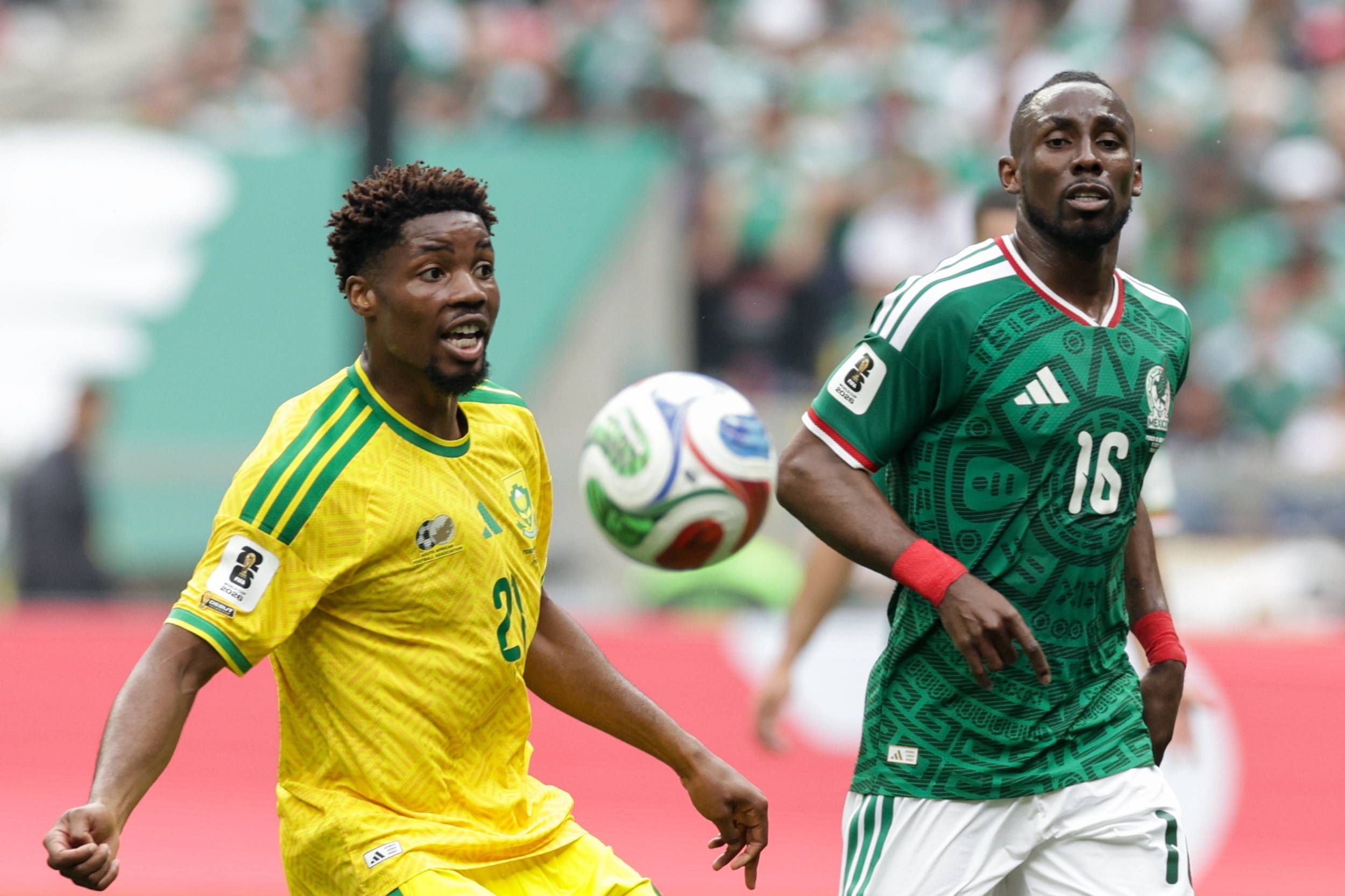 Ime Okon and Julian Quinones fight for the ball in the 2026 FIFA World Cup football match between Mexico and South Africa