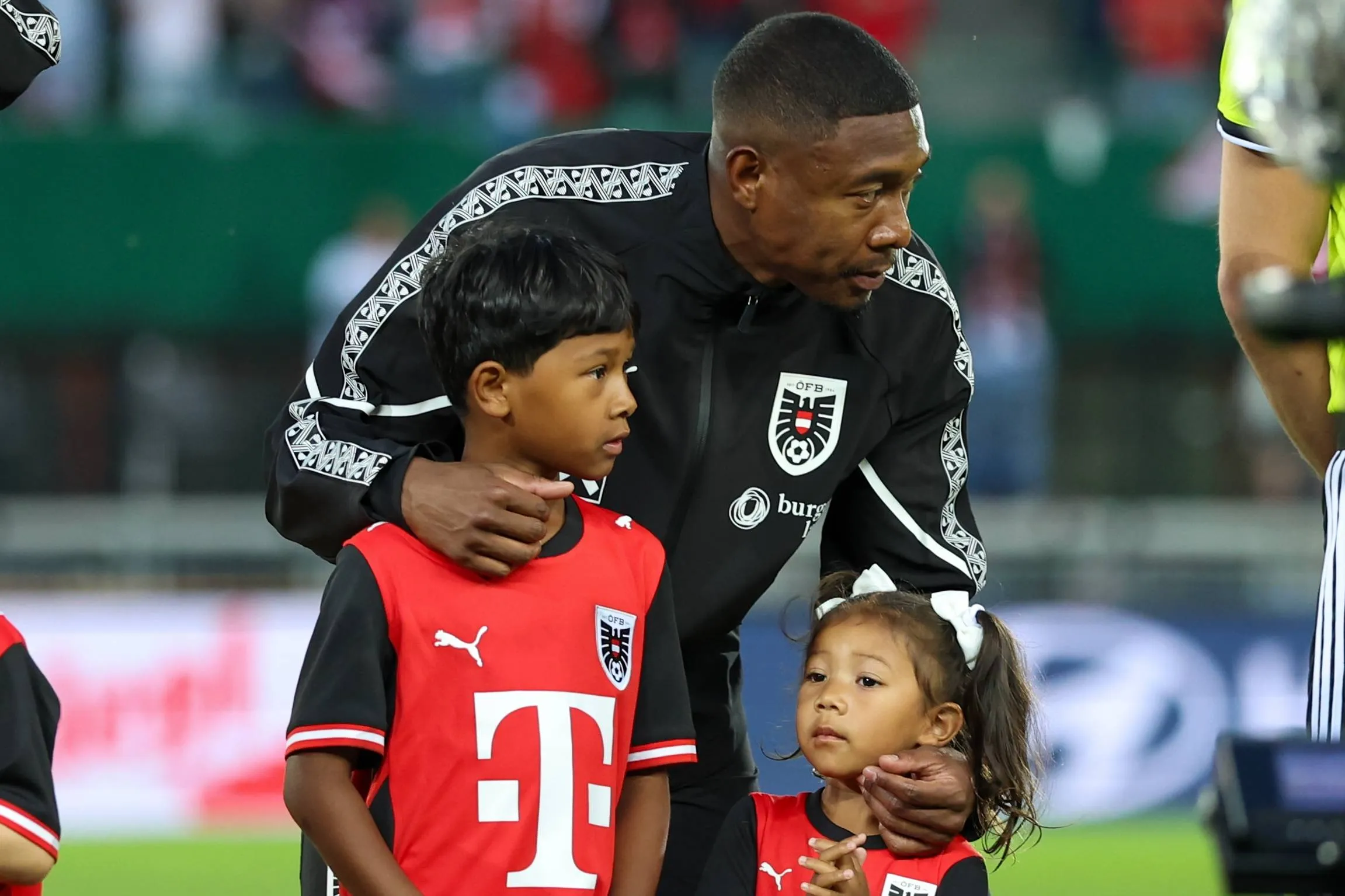 David Alaba walking onto the pitch with his children as mascots