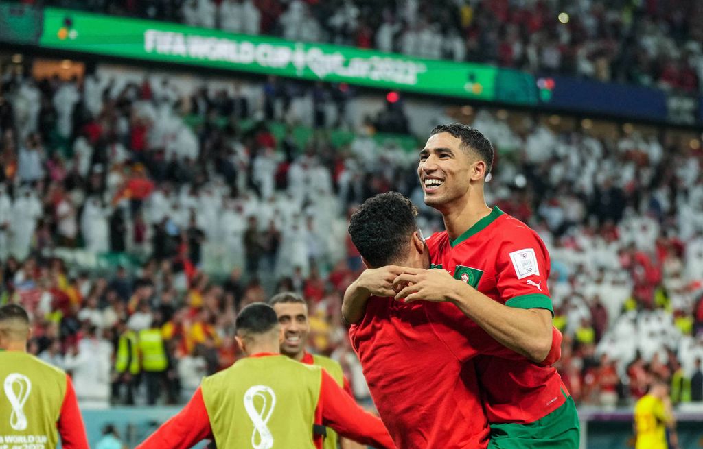 Hakimi celebrating with his teammate after Morocco knocked Spain out of the World Cup