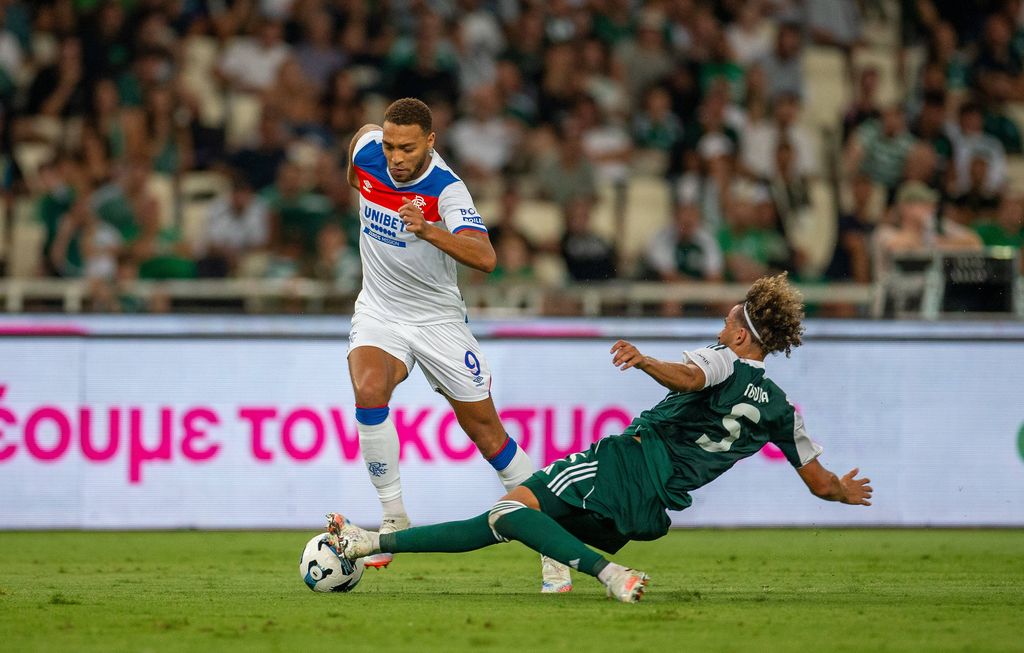 Ahmed Touba of Panathinaikos slide tackles Cyriel Dessers of Ranger