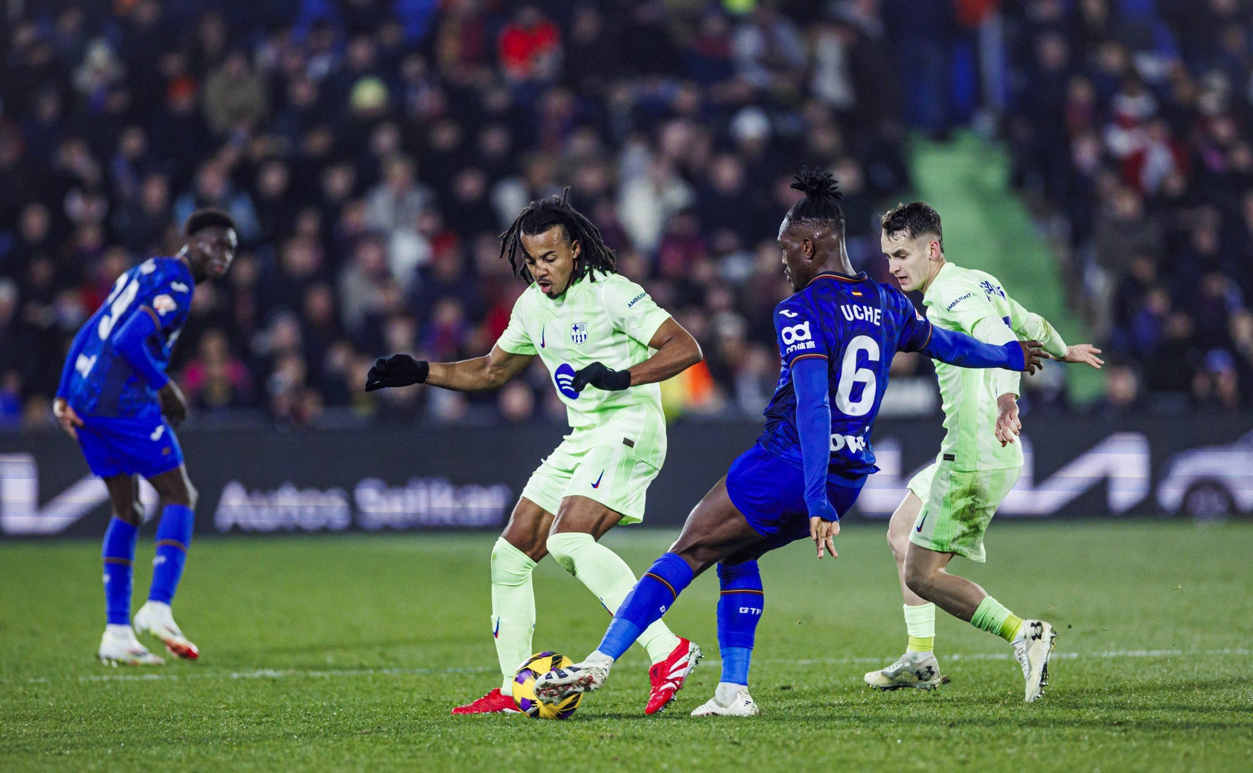 Jules Kounde of FC Barcelona L battles for the ball with Christantus Uche of Getafe CF