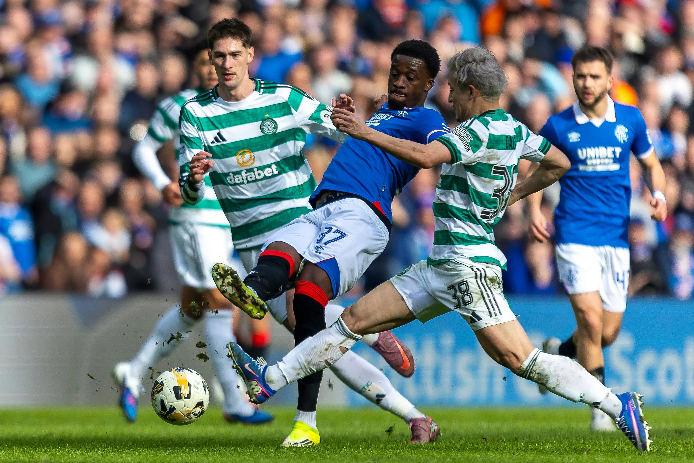 Super Eagles defender Emmanuel Fernandez of Rangers FC stretches to get to the ball ahead of Daizen Maeda