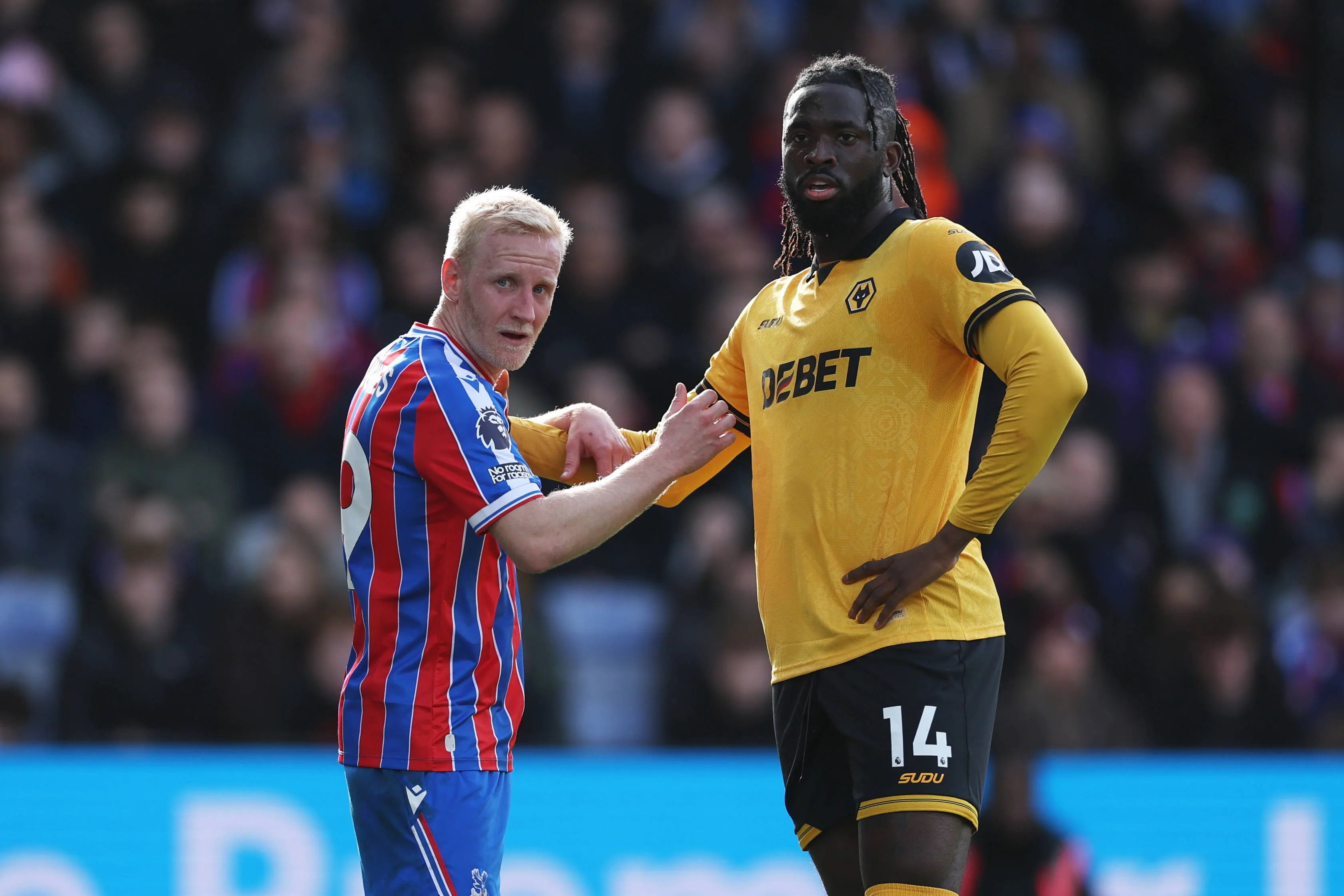 Will Hughes in action with Tolu Arokodare during the Premier League match between Crystal Palace and Wolverhampton Wanderers at Selhurst Park