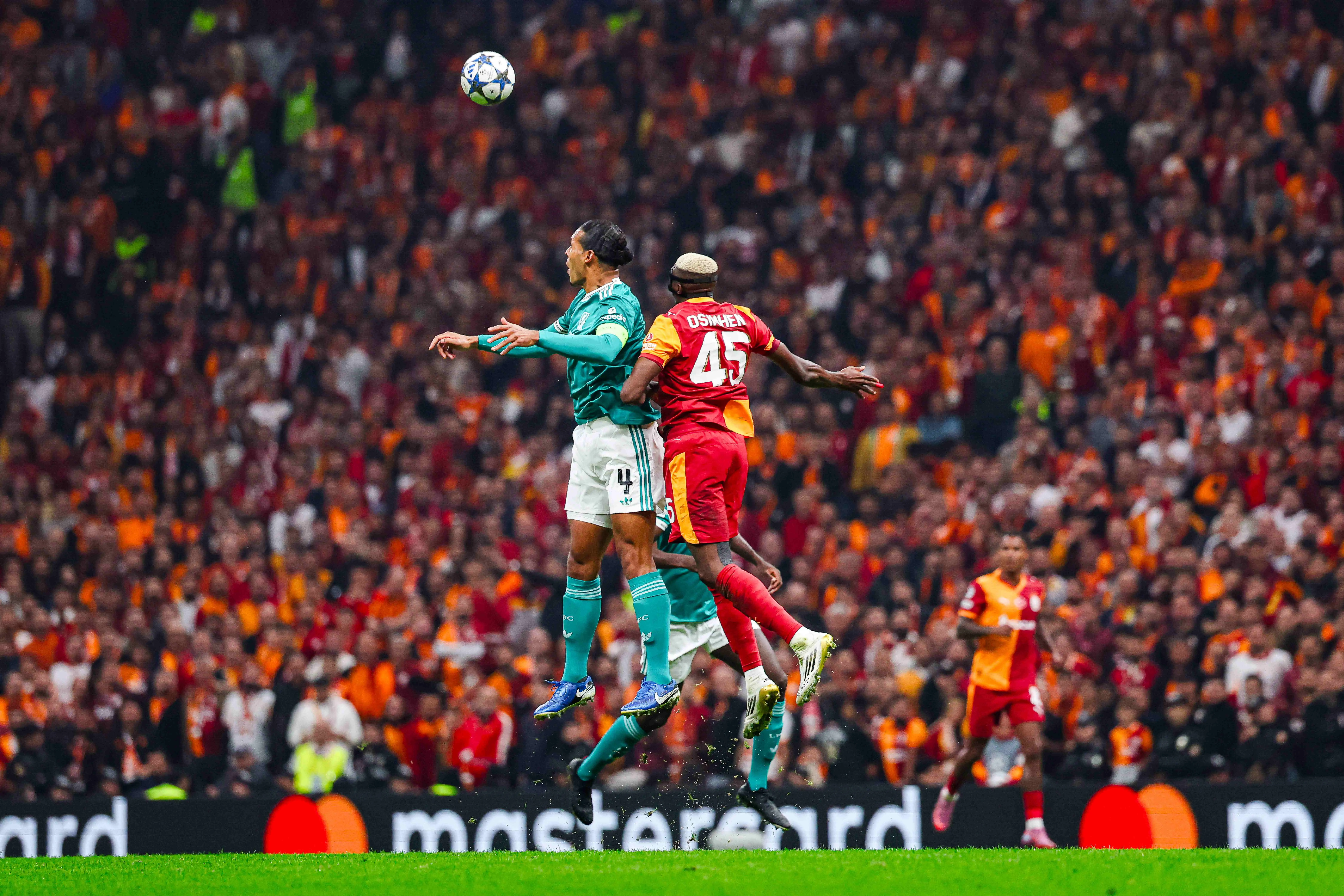 Victor Osimhen contests for the ball with Virgil Van Dijk