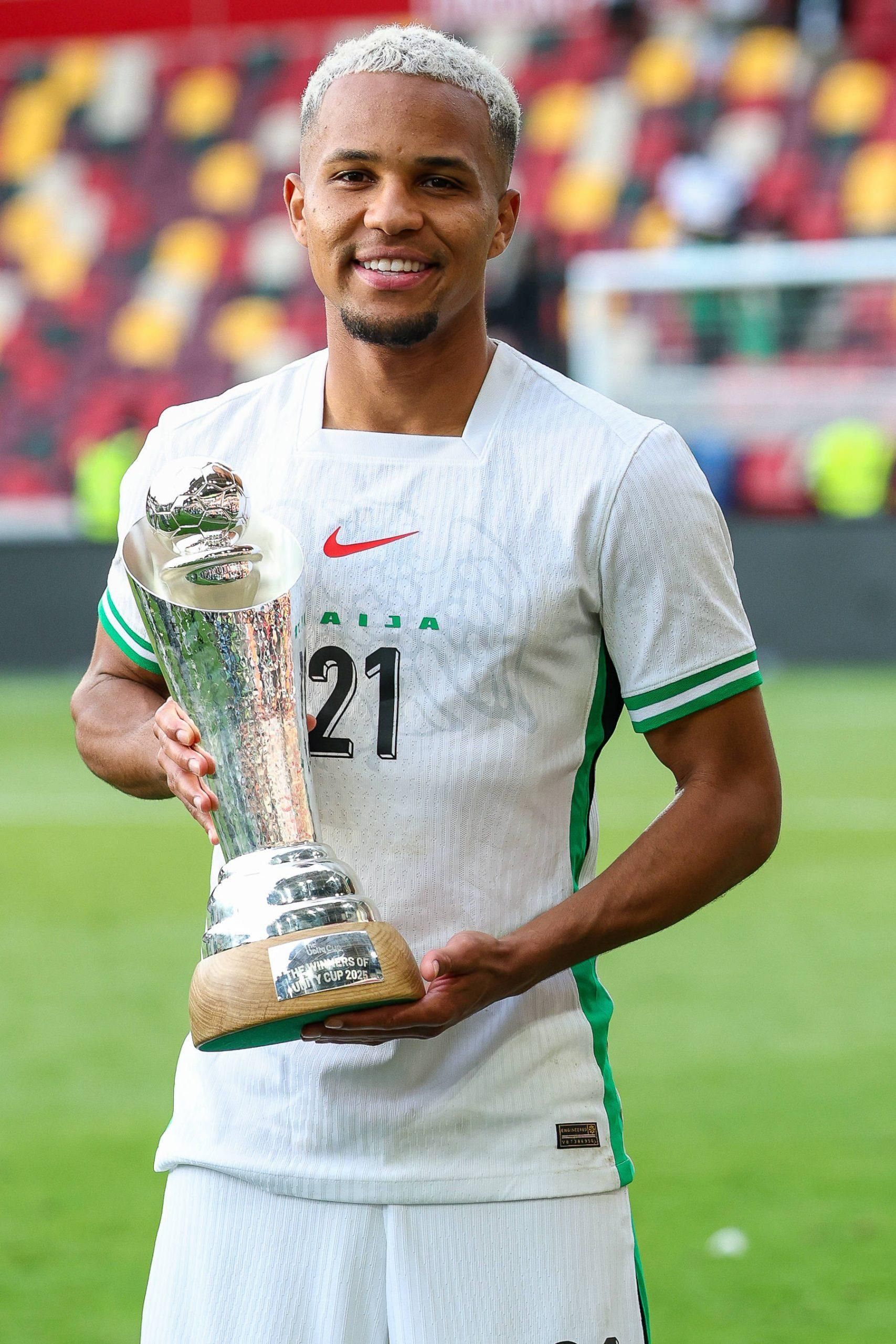 Nigeria defender Felix Agu poses with the cup after the Unity Cup Final between Jamaica and Nigeria at Gtech Community Stadium