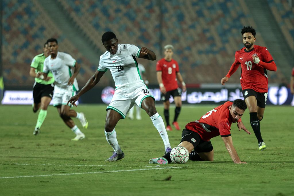 Mohamed Hany is in action with Super Eagles Ebenezer Akinsanmiro