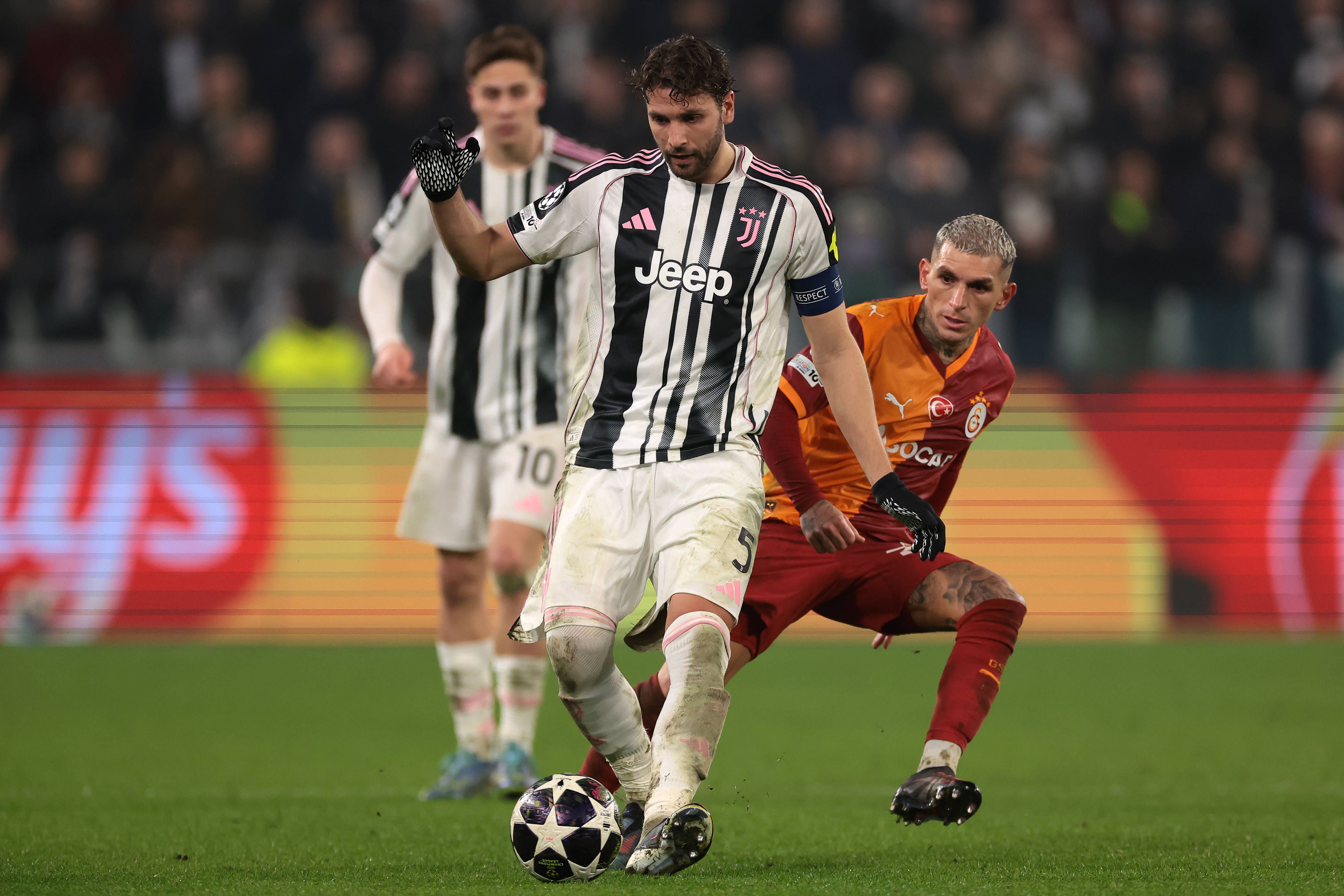 Manuel Locatelli of Juventus passes the ball as he is pursued by Lucas Torrerira of Galatasaray SK